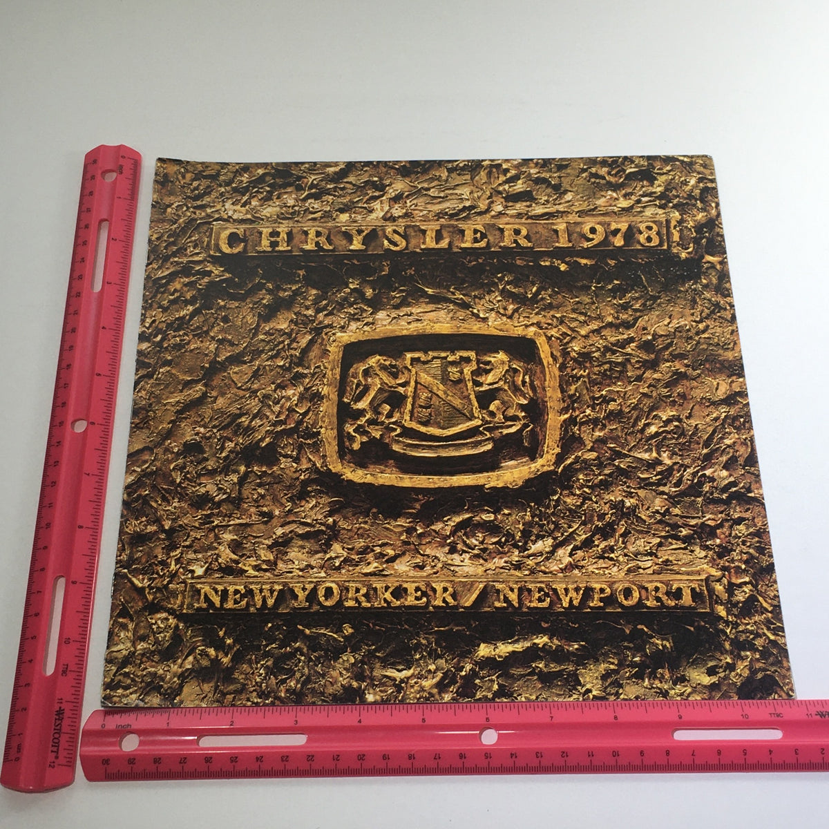 Cover of the 1978 Chrysler New Yorker/New Port Features dealership car auto brochure catalog, showcasing a textured gold design with the Chrysler logo and model names prominently displayed.