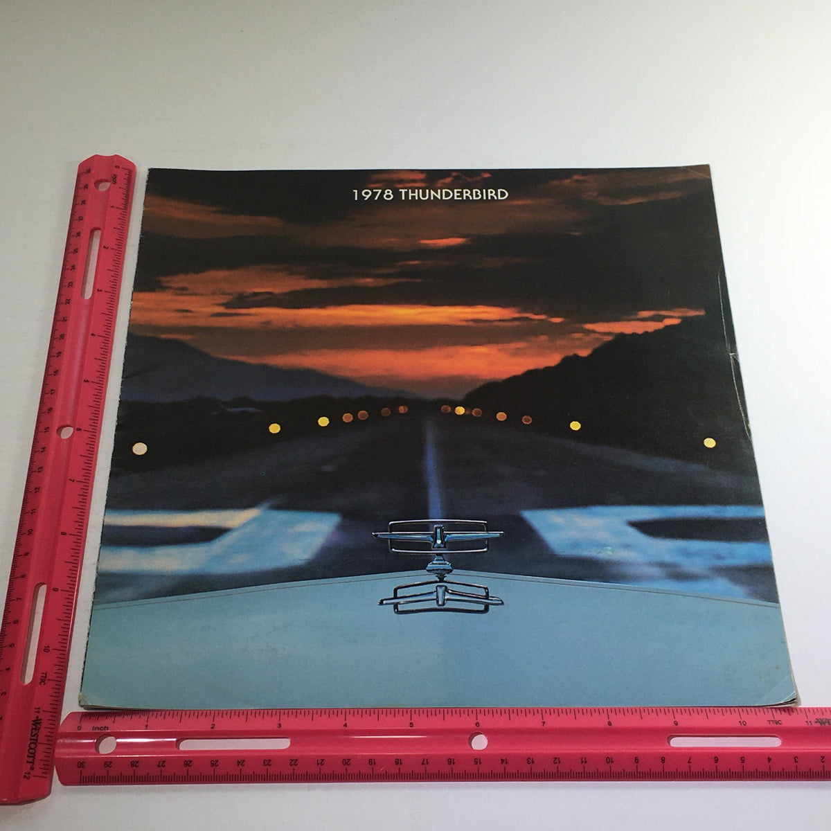 Front cover of the 1978 Ford Thunderbird Town Landau Dealership Car Brochure featuring a captivating sunset image over a road, emphasizing the elegance of the Thunderbird.