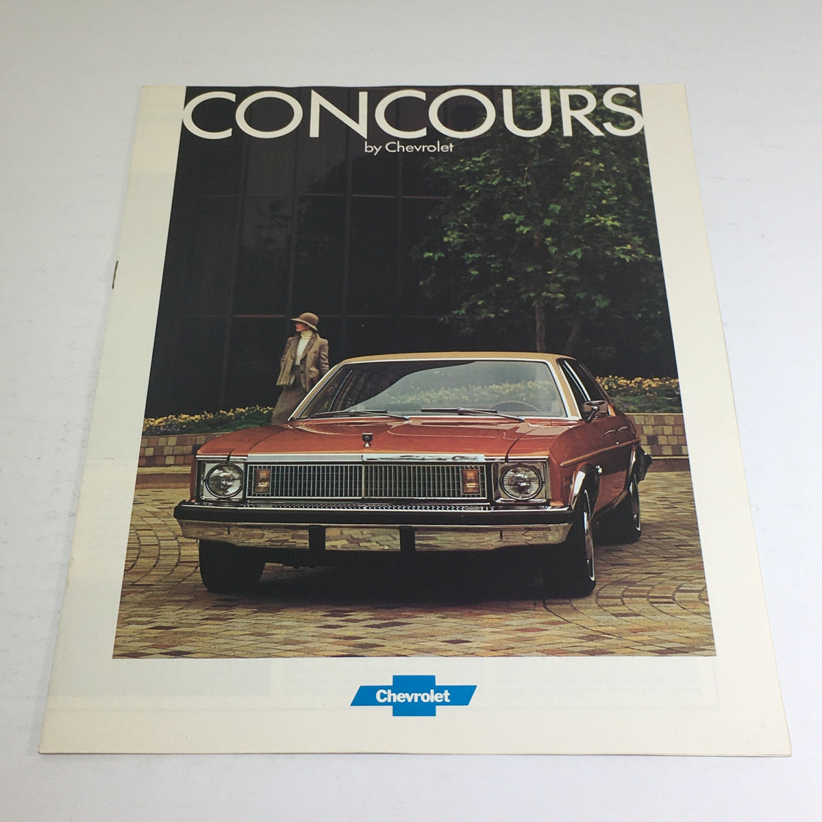 1977 Concours by Chevrolet Specifications Dealership Car Auto Brochure Catalog featuring a classic Concours car displayed outside a building.