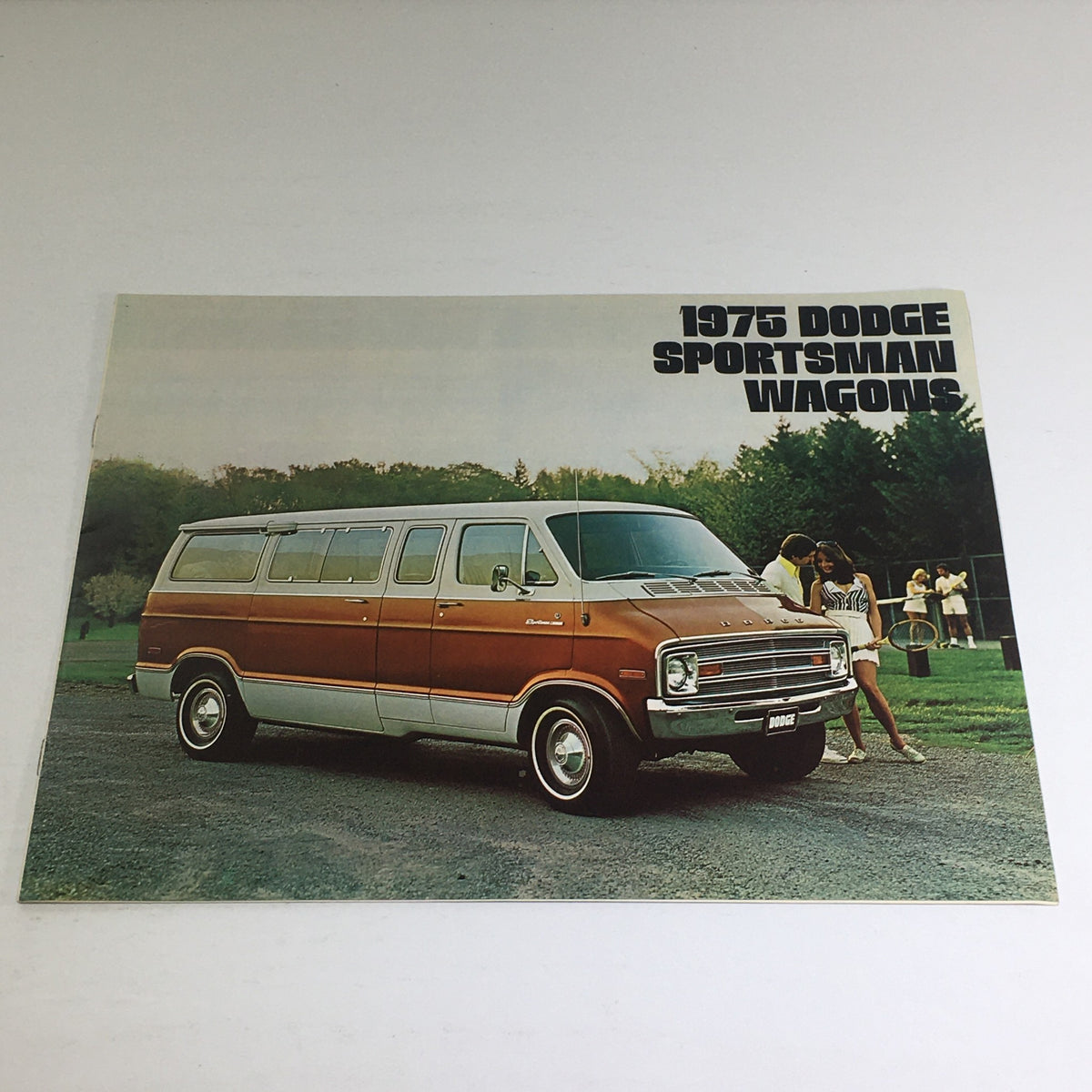 1975 Dodge Sportsman Wagons Optional Equipment Car Auto Brochure Catalog featuring a Dodge Sportsman wagon parked on a grassy area with people in the background.