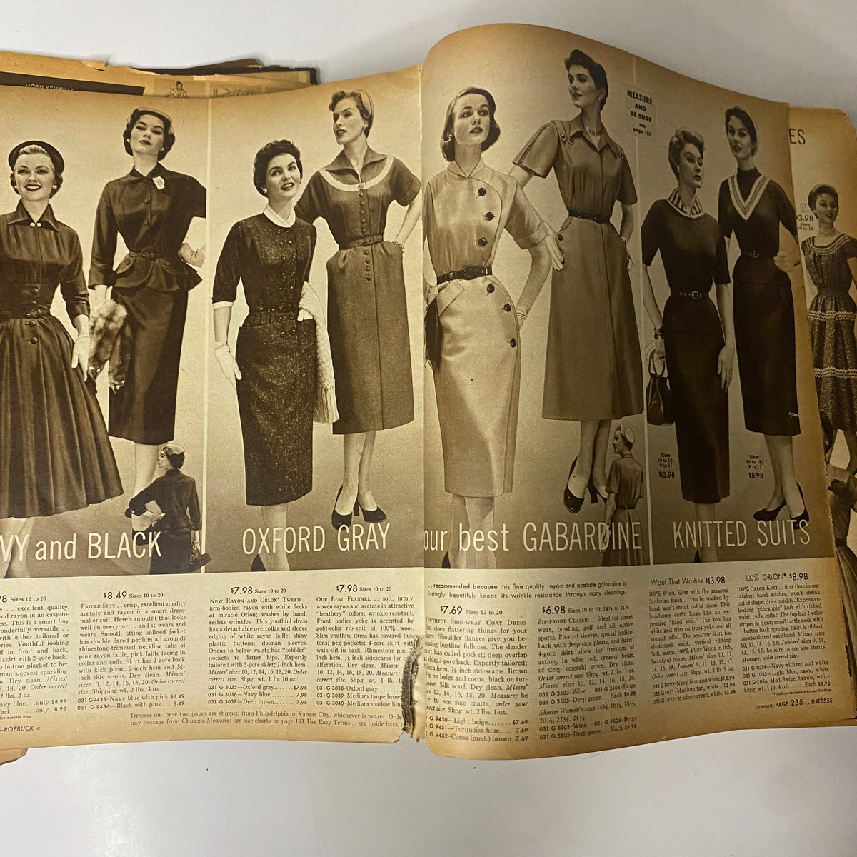 Interior page of the 1954 Sears Roebuck and Co. Fall and Winter Catalog showcasing stylish dresses available in multiple colors and patterns, priced between $7.98 and $8.49.
