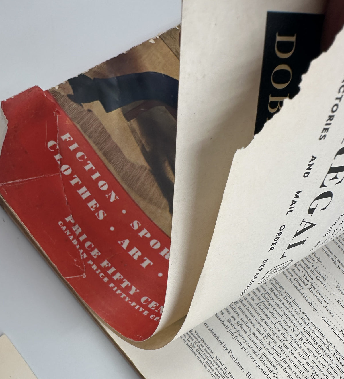 Inside view of Esquire Magazine April 1942, revealing significant creases and wear on the pages while displaying the magazine's bold article sections.