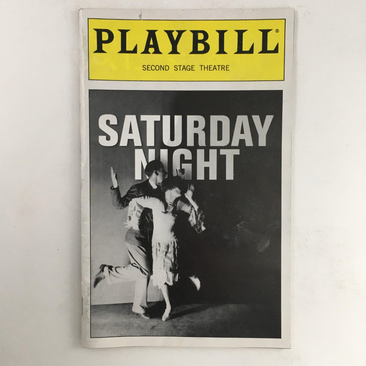 Cover of the 2000 Playbill for 'Saturday Night' by Julius Epstein and Kathleen Marshall, featuring bold typography and theatrical imagery.