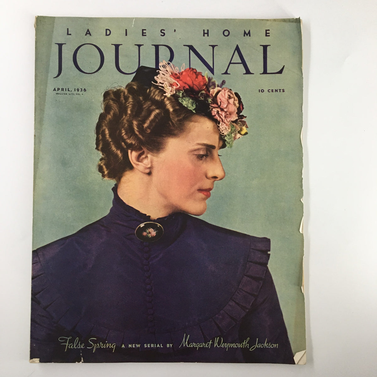 Cover of Ladies' Home Journal Magazine from April 1936 featuring a woman with a floral headpiece, embodying the theme of 'Spring Fever in the Laundry'.