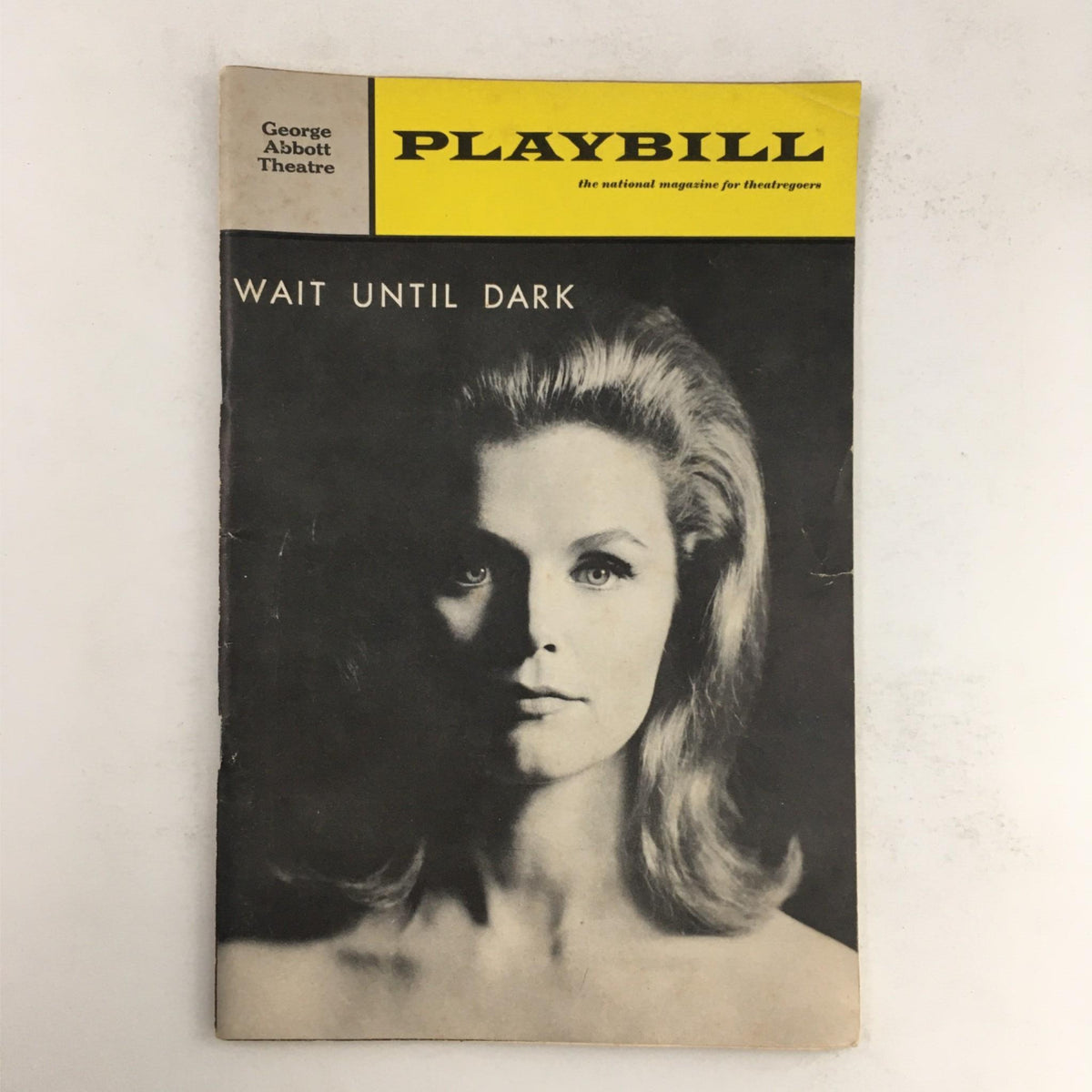 1966 Playbill for 'Wait Until Dark' featuring a striking black and white image of a woman, representing the suspenseful theme of the play by Frederick Knott, performed at the George Abbot Theatre.