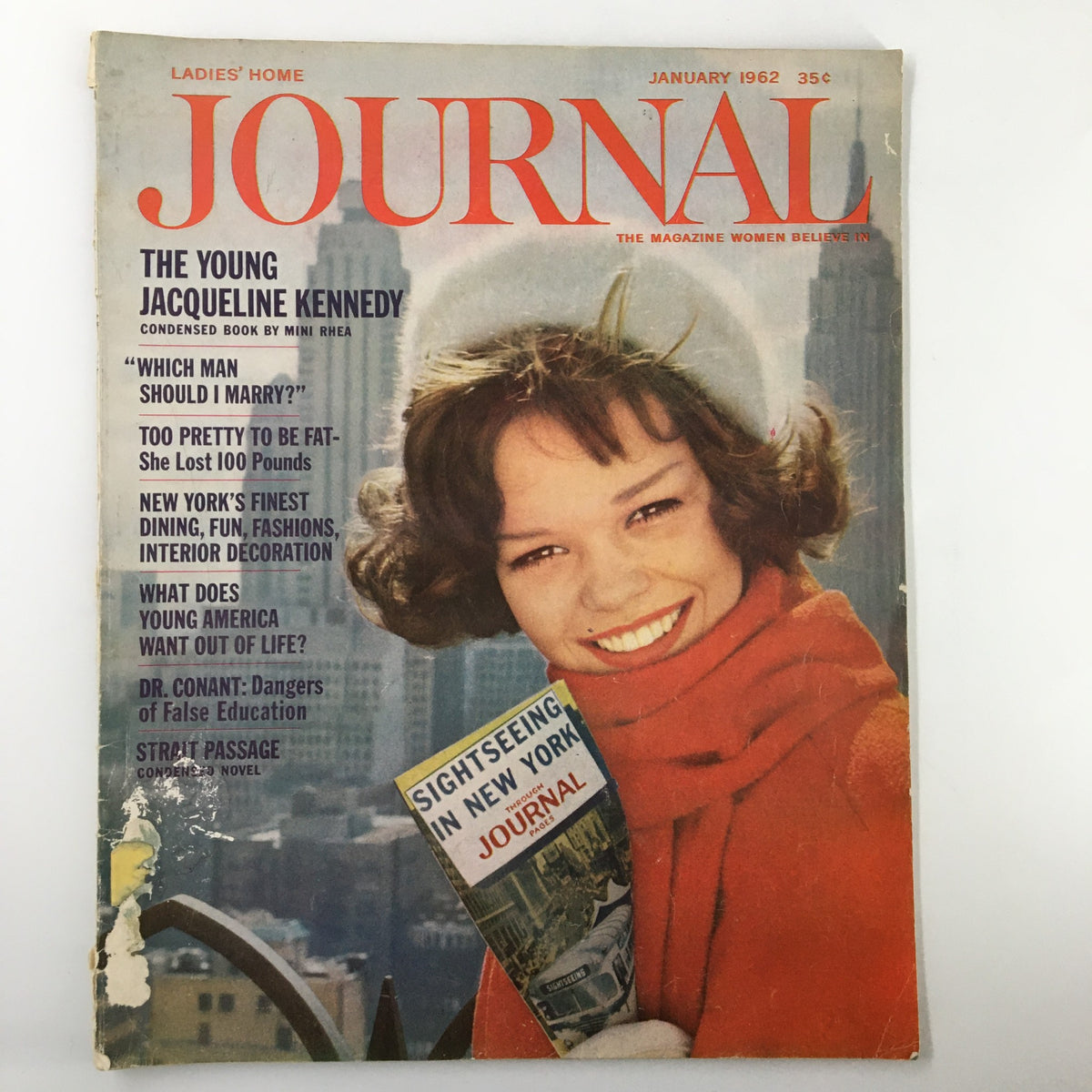 Cover of Ladies' Home Journal Magazine January 1962 featuring The Young Jacqueline Kennedy, showcasing her smile and winter attire against an urban backdrop, encapsulating 1960s fashion and culture.