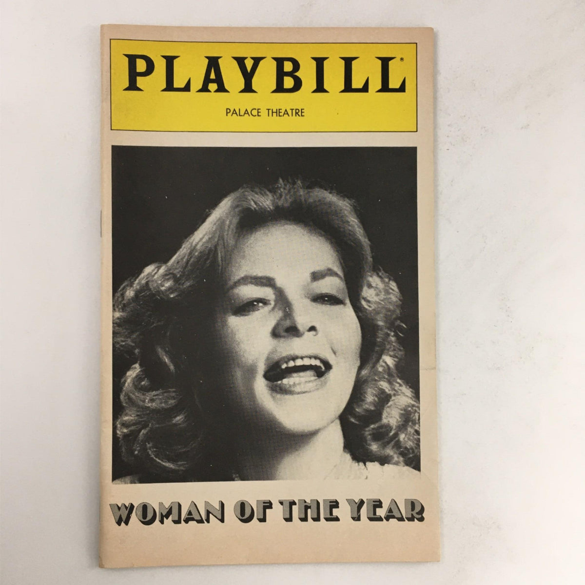 Vintage 1981 Playbill for 'Woman of the Year' featuring Lauren Bacall, presented at The Palace Theatre. The cover showcases a black and white photograph of Lauren Bacall performing.