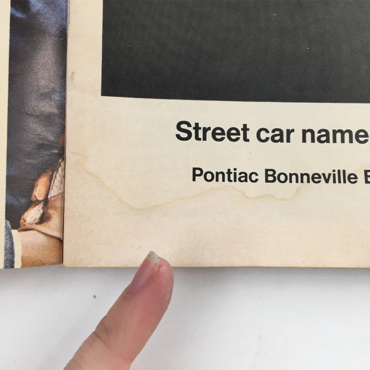 Close-up of the 1967 Playbill There's A Girl In My Soup showing a faded advertisement for Pontiac Bonneville, highlighting the historical context of the era.