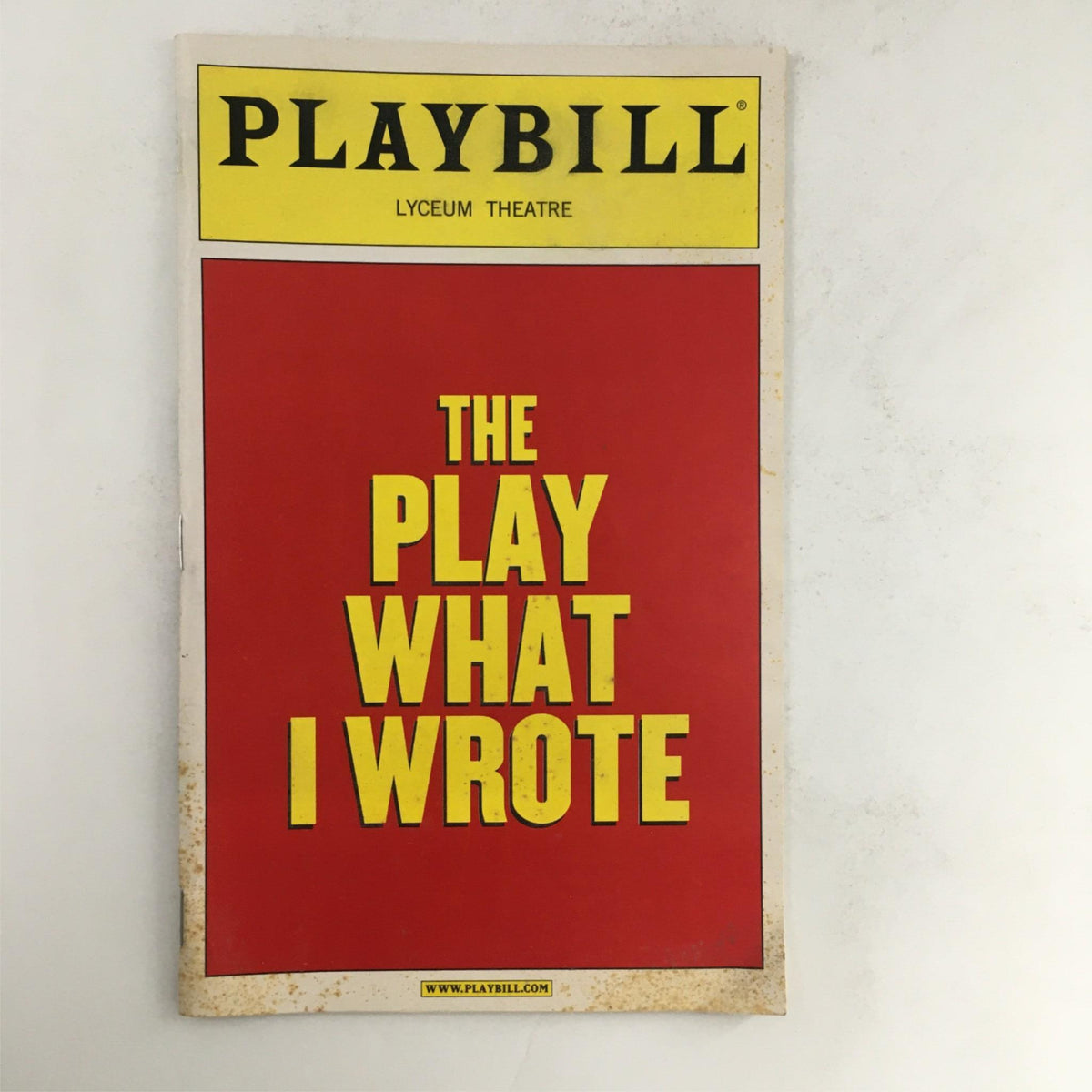 2003 Playbill for The Play What I Wrote featuring vibrant red cover with yellow text, produced at the Lyceum Theatre.