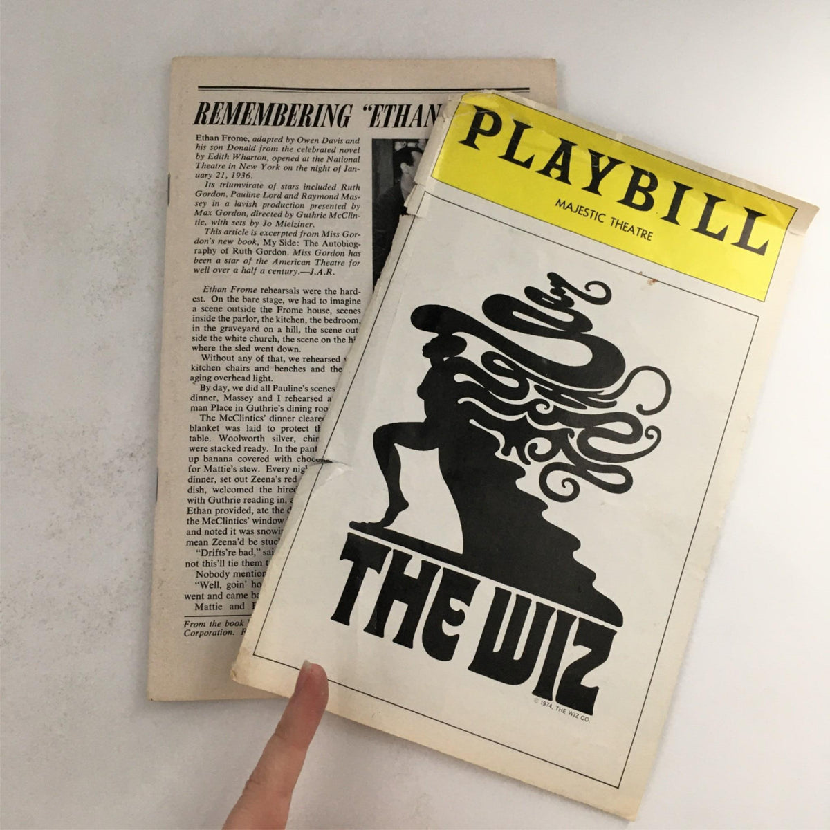 Close-up view of the 1976 Playbill The Wiz showing the cover alongside another page, highlighting the vintage style.