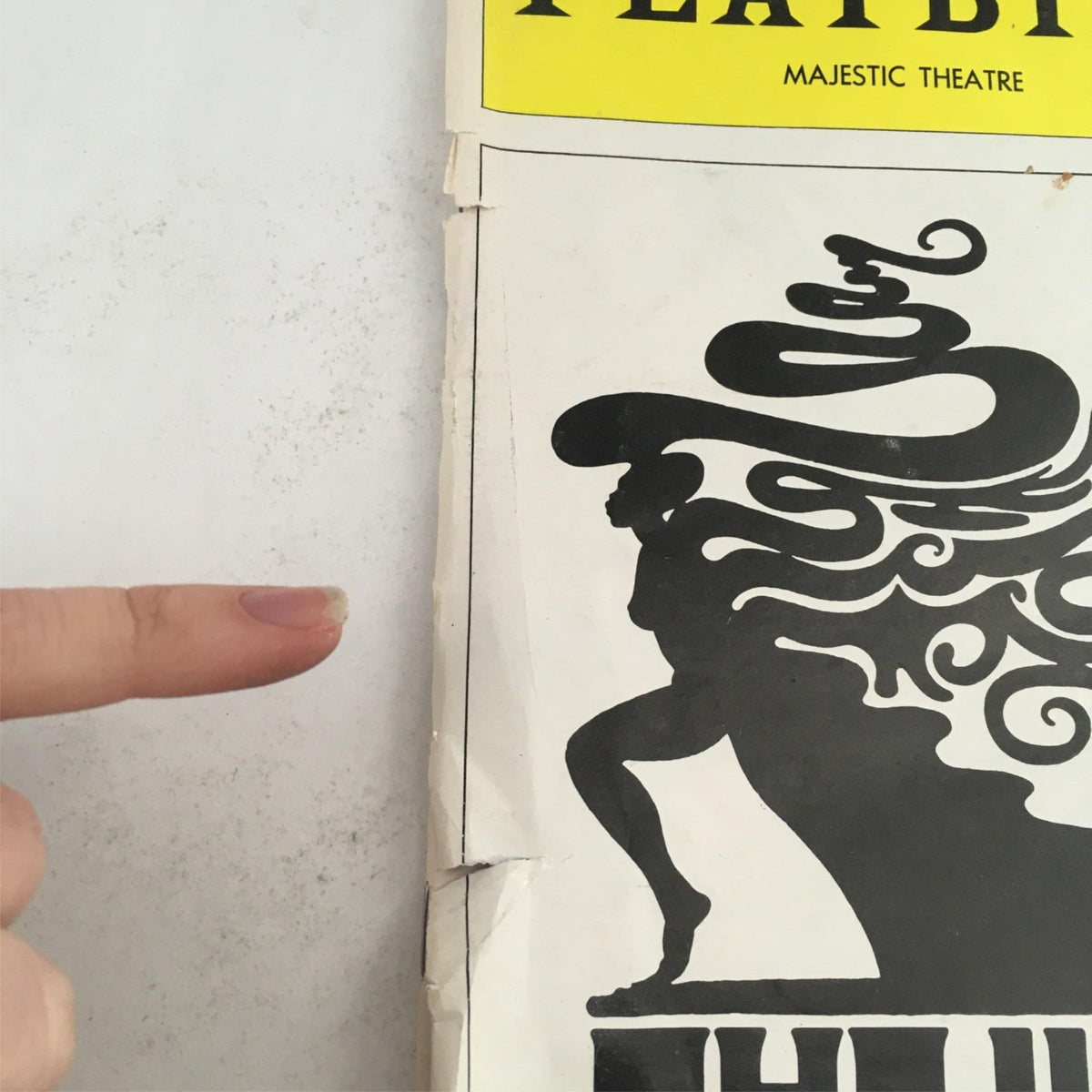 Detailed shot of the edge of the 1976 Playbill The Wiz, showing signs of wear and character of this collectible item.