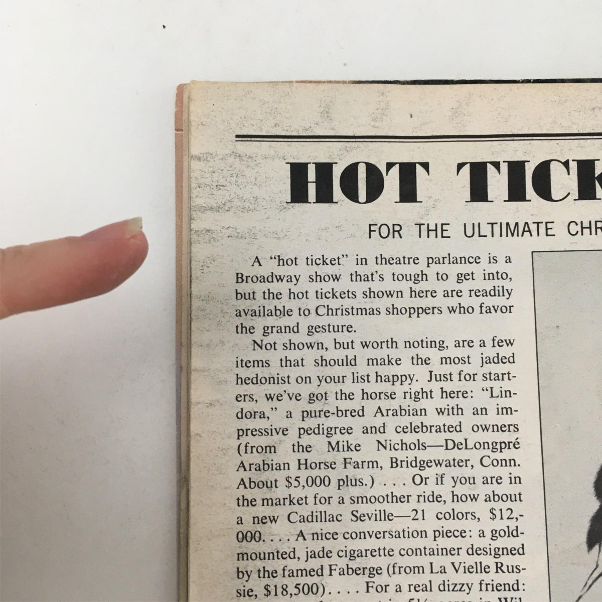 Detail of the 1976 Playbill for 'The Wiz' by Ken Harper and George Faison at Majestic Theatre, showcasing the cover with slight wear and a finger pointing at the edge, indicative of its vintage status.