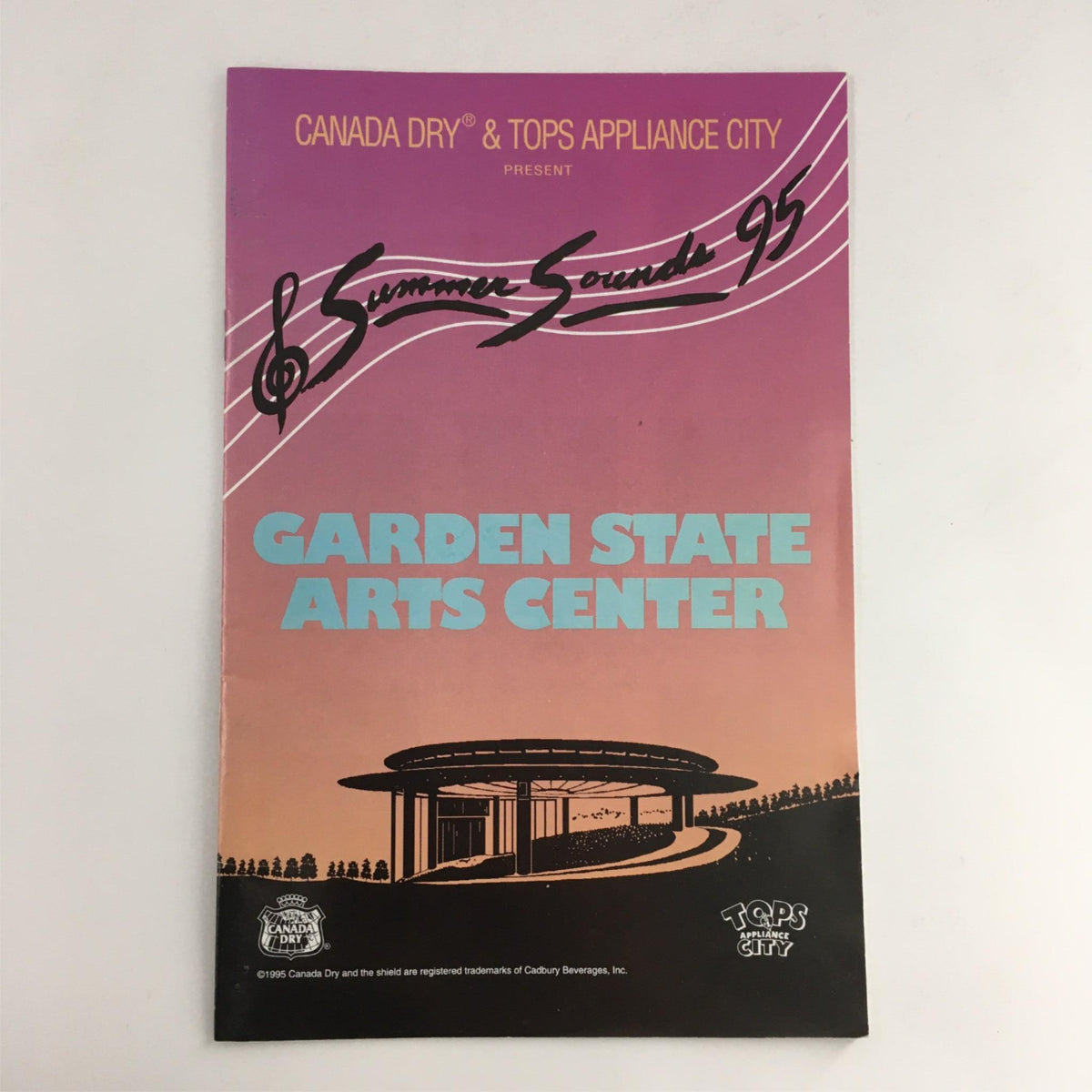Cover of Summer Sounds '95 program featuring the Garden State Arts Center logo and event title, showcasing a vibrant pink and blue design.