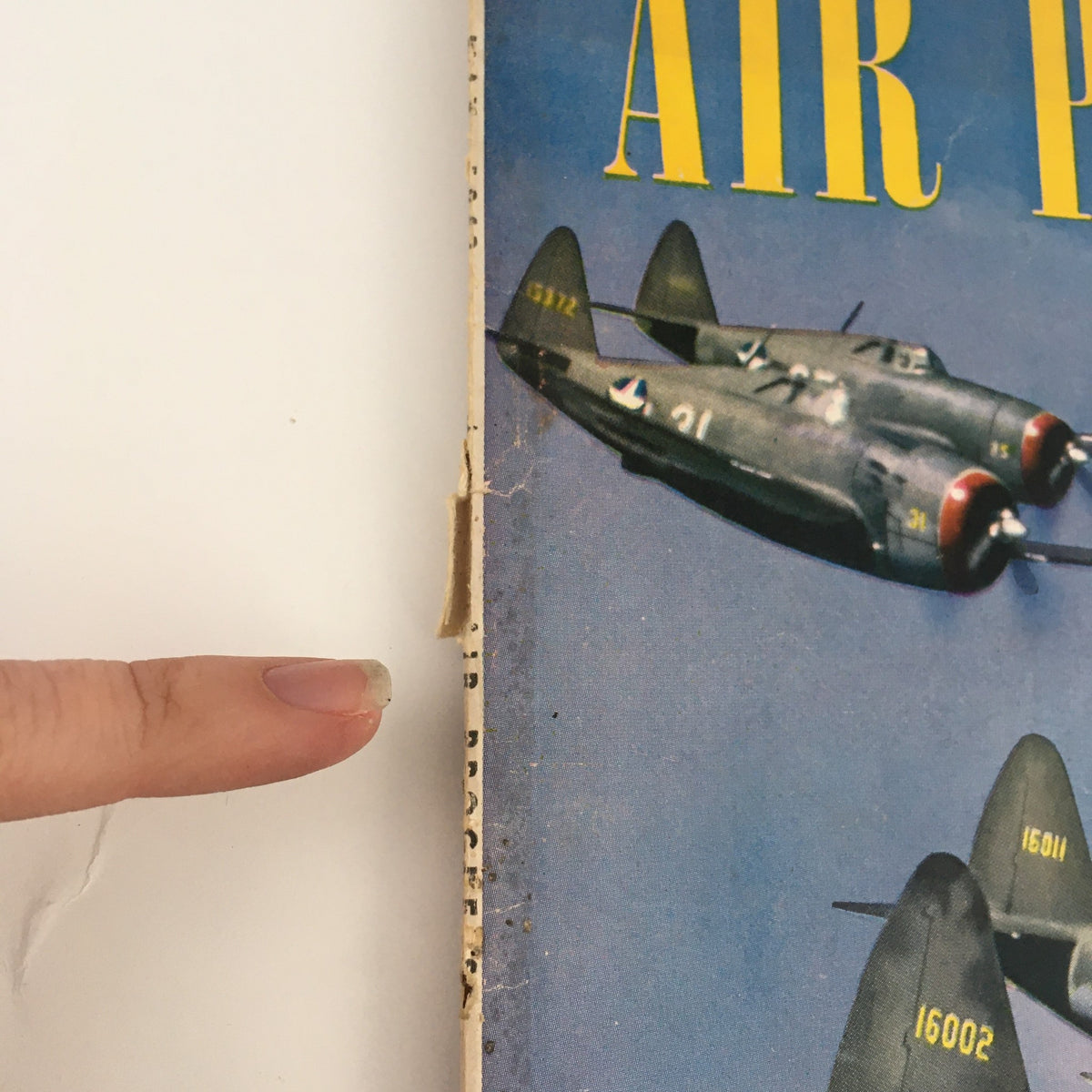 Side view of the spine of Air Progress Magazine May 1943, showing slight wear and the magazine's title.