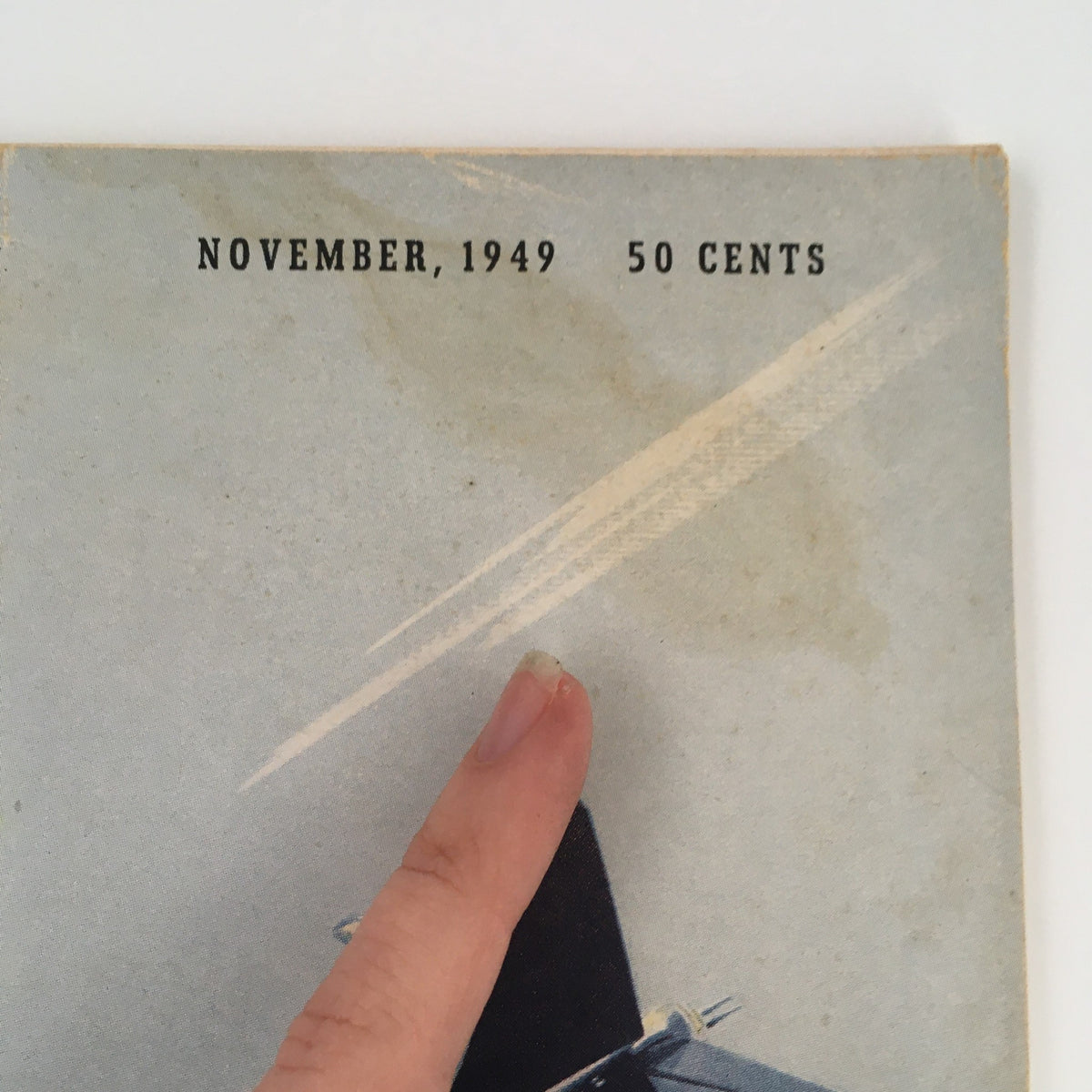Upper corner of the Aero Digest Magazine November 1949 Vol 59 #5 cover, showing the issue date and price, emphasizing its vintage nature.