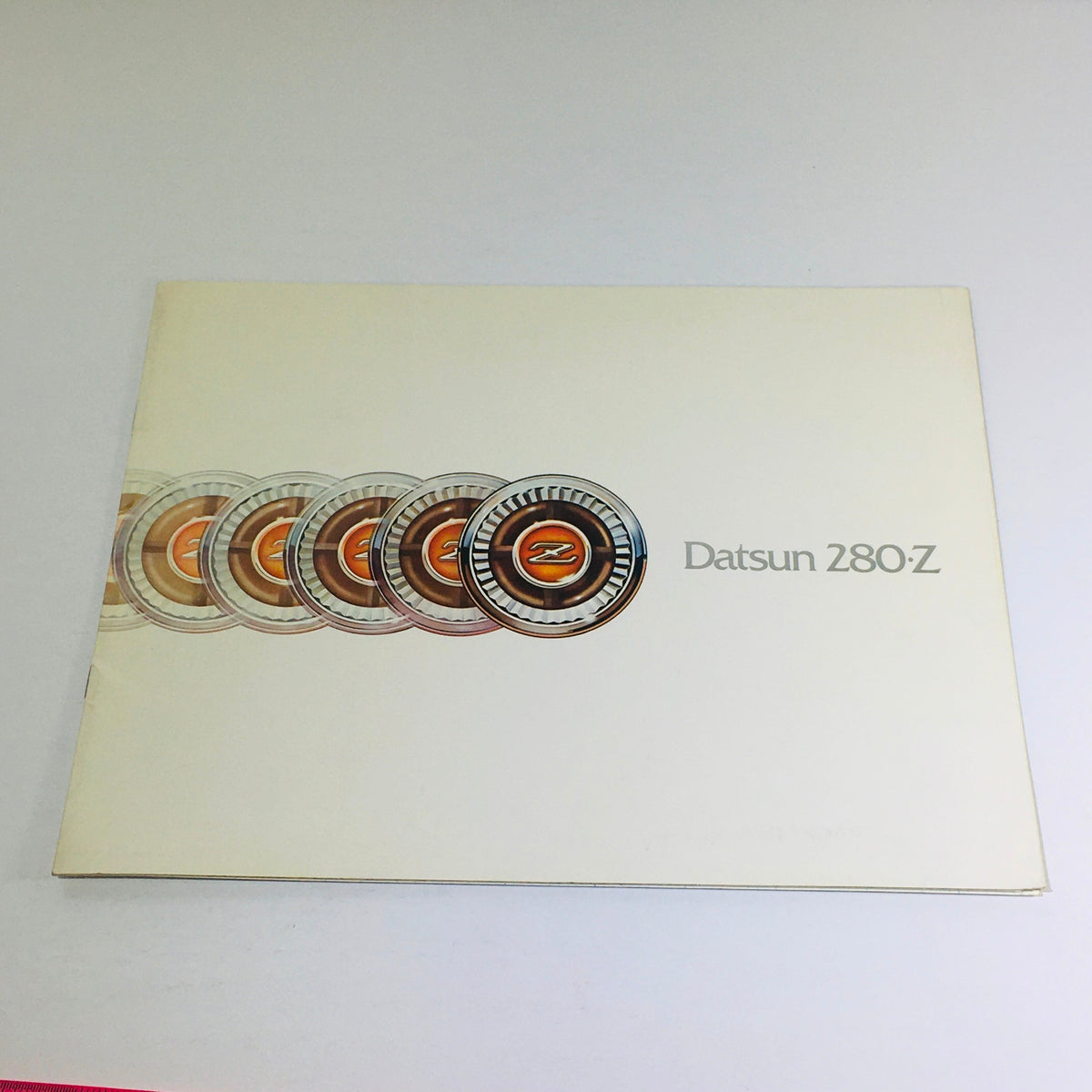Cover of the 1976 Datsun 280-Z Showroom Specifications Dealership Car Auto Brochure Catalog featuring iconic Datsun logo design.