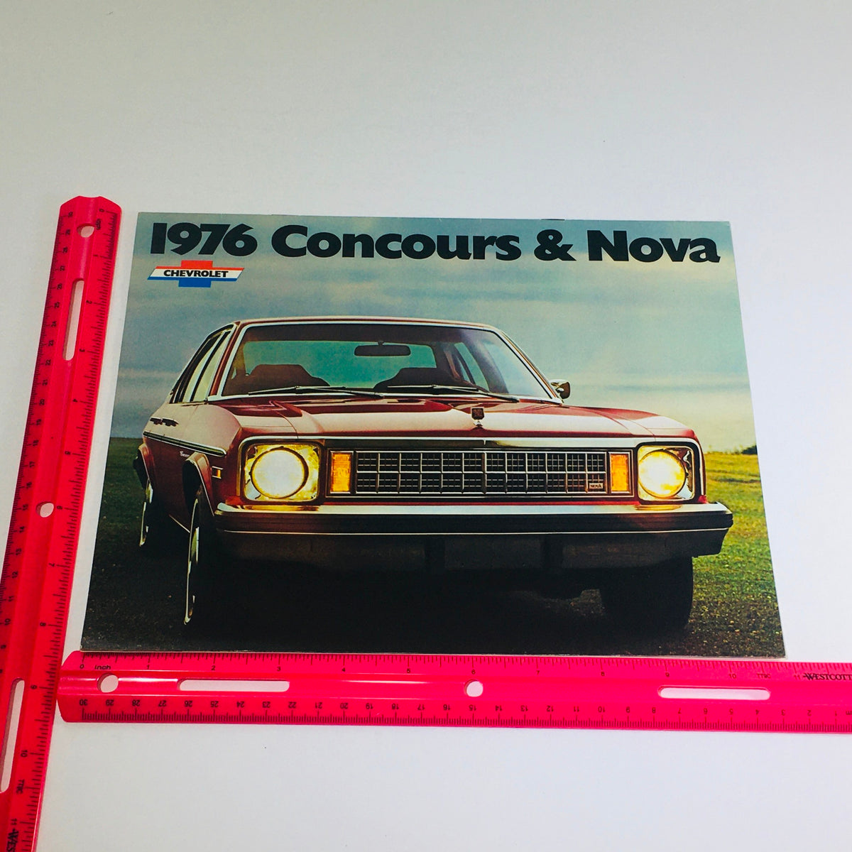 1976 Chevrolet Concours & Nova Dealership Car Auto Brochure Catalog with a vibrant front cover showcasing a red Chevrolet Concours car, captured in a scenic outdoor setting.