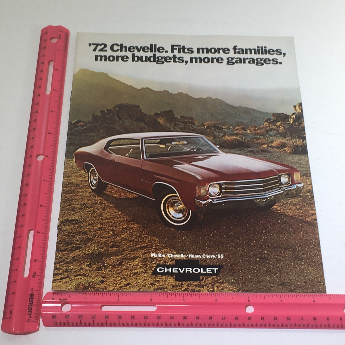 1972 Chevrolet Malibu/Chevelle/Chevy/SS Dealership Car Auto Brochure Catalog with a ruler placed alongside the front cover featuring a red Chevelle and promotional text.