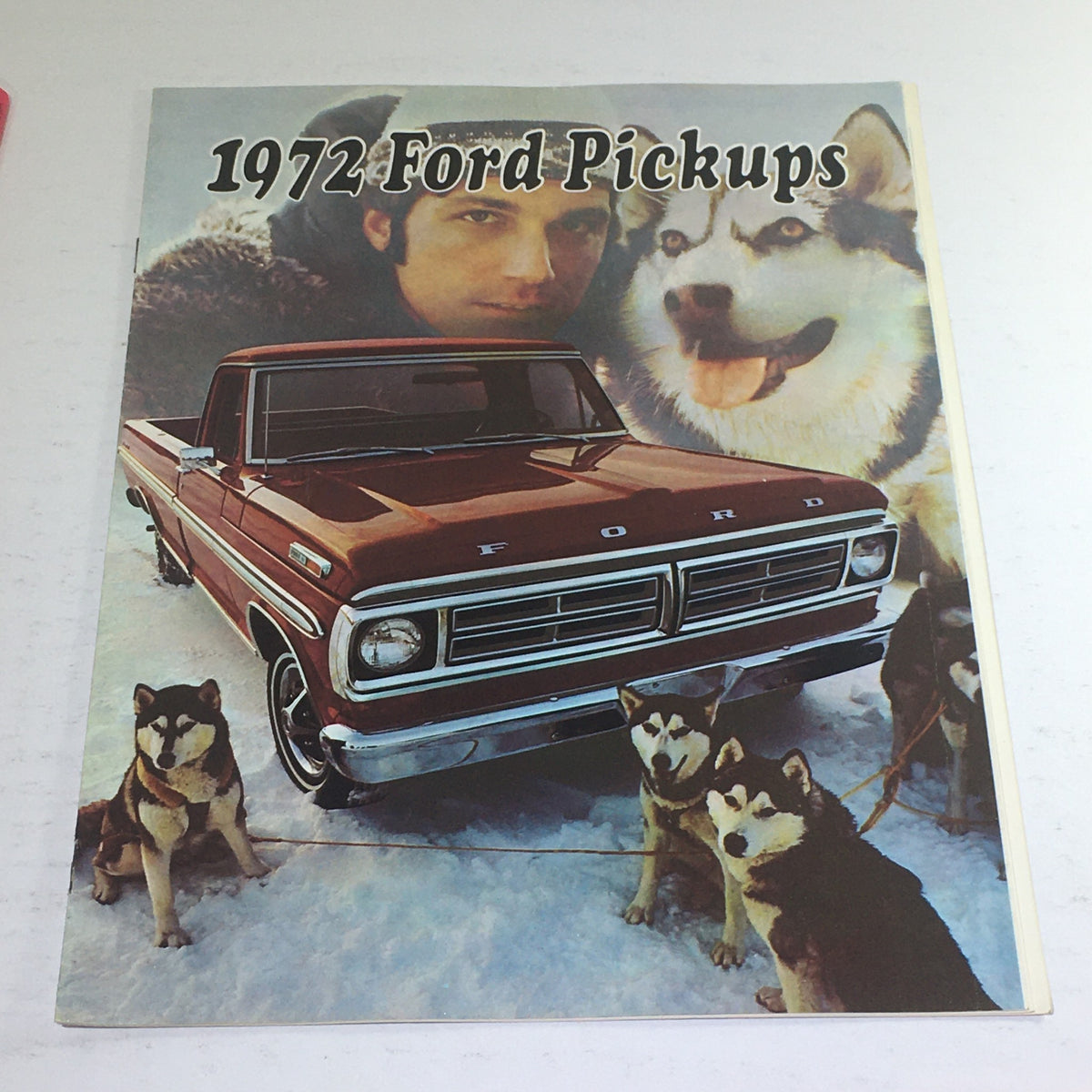 1972 Ford Pickups Colors & Combination Dealership Car Auto Brochure Catalog showcasing a red Ford pickup truck in snowy landscape with a man and two husky dogs.