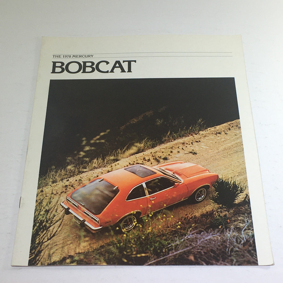 Cover of the 1978 Lincoln-Mercury Bobcat Runabout Wagon dealership brochure showcasing an orange Mercury Bobcat on a dirt road.