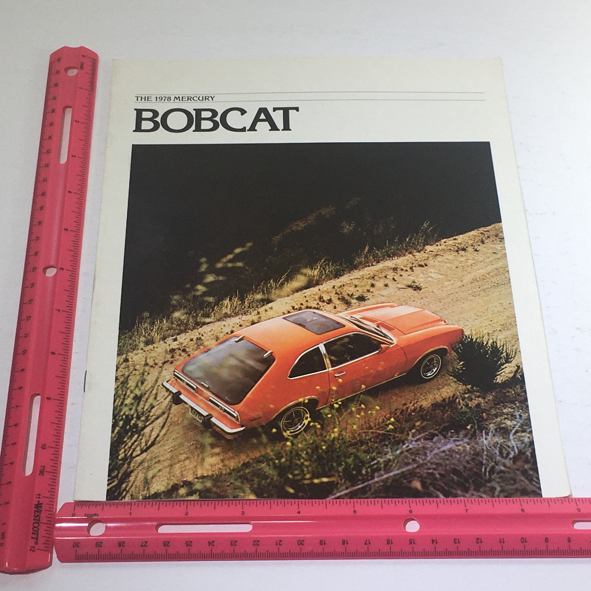 Cover of the 1978 Lincoln-Mercury Bobcat brochure alongside a ruler for size reference, emphasizing the design and vehicle details.
