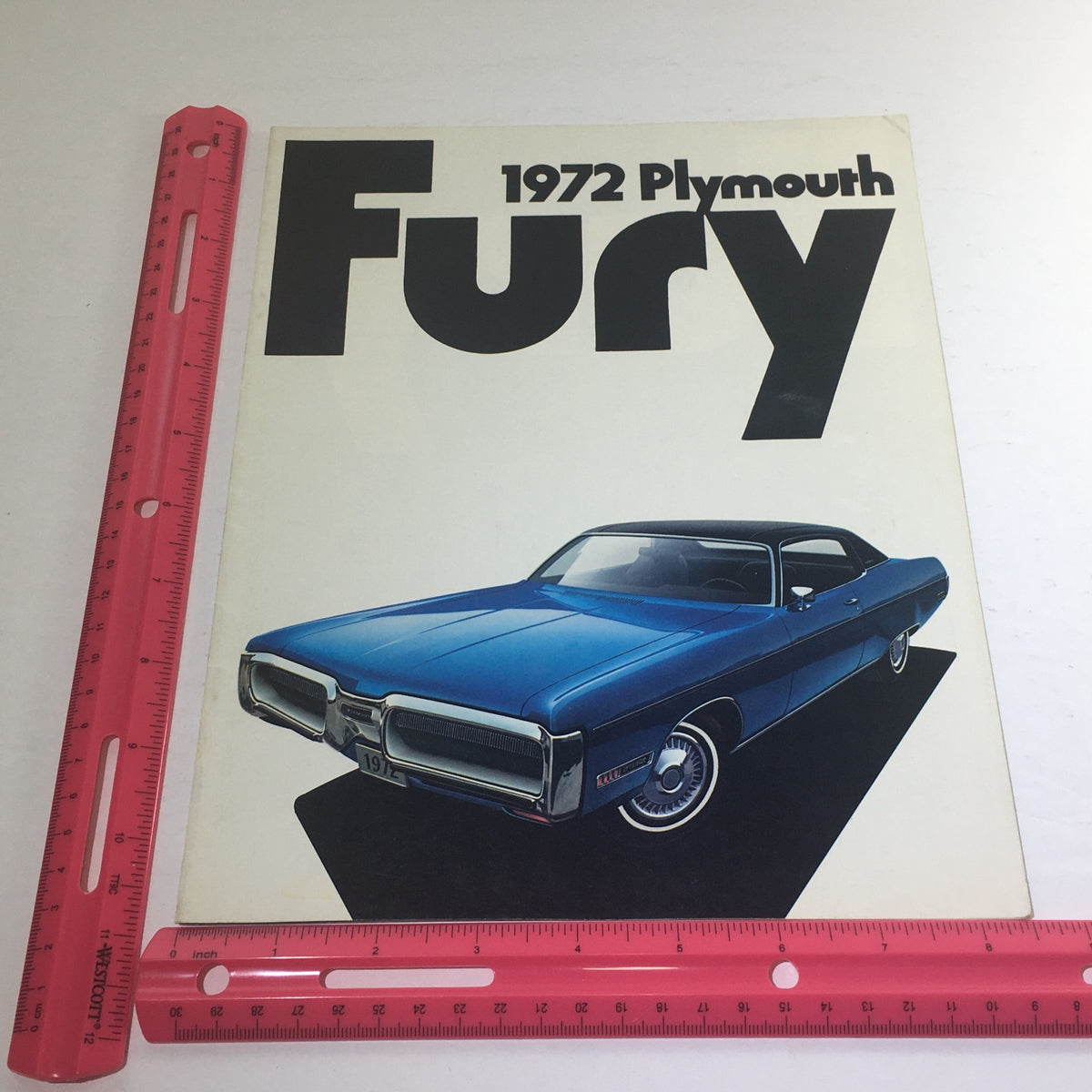 1972 Plymouth-Chrysler Fury Gran Coupe dealership brochure cover displayed alongside a ruler for size reference.