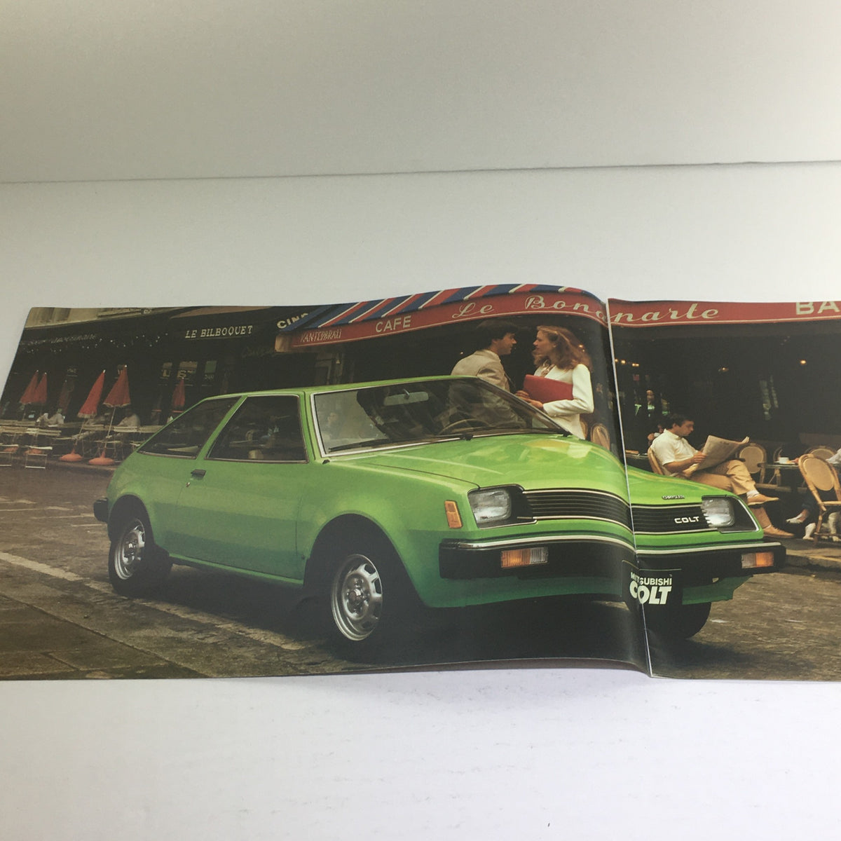 1979 Chrysler-Mitsubishi Colt 2-Door/4-Door Dealership Car Auto Brochure Catalog featuring a green Mitsubishi Colt parked on a city street, showcasing the car's design and highlighting its urban appeal.