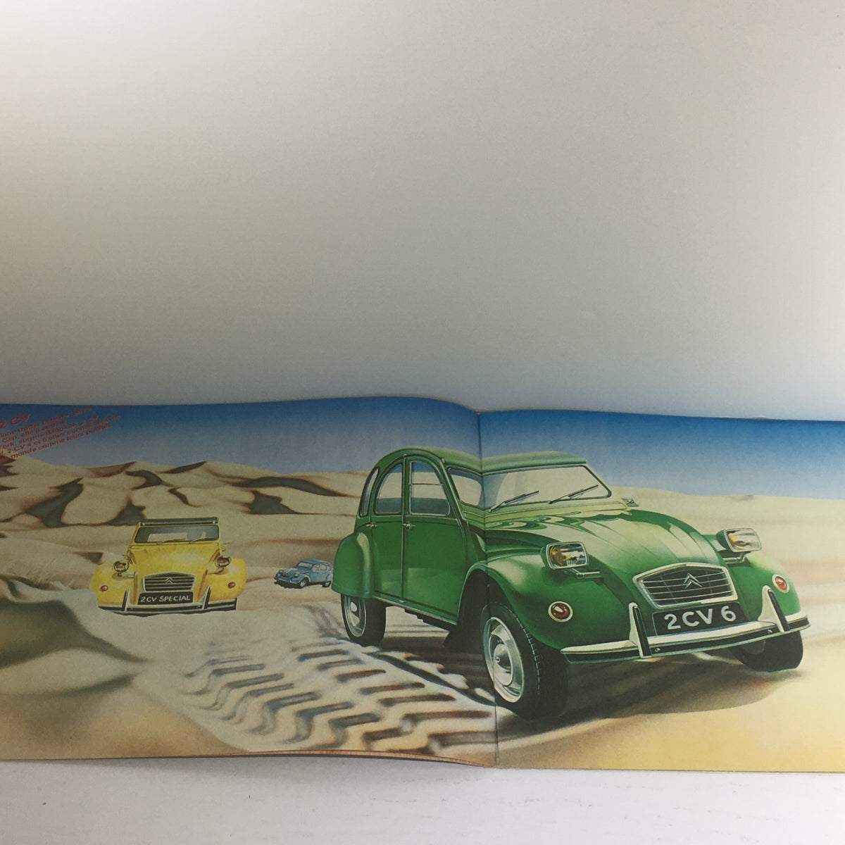 Interior pages of the 1975 Les Petites Citroen 2 CV 6 (French) Dealership Car Auto Brochure Catalog showcasing a green Citroen 2 CV 6 and a yellow model in a desert setting.
