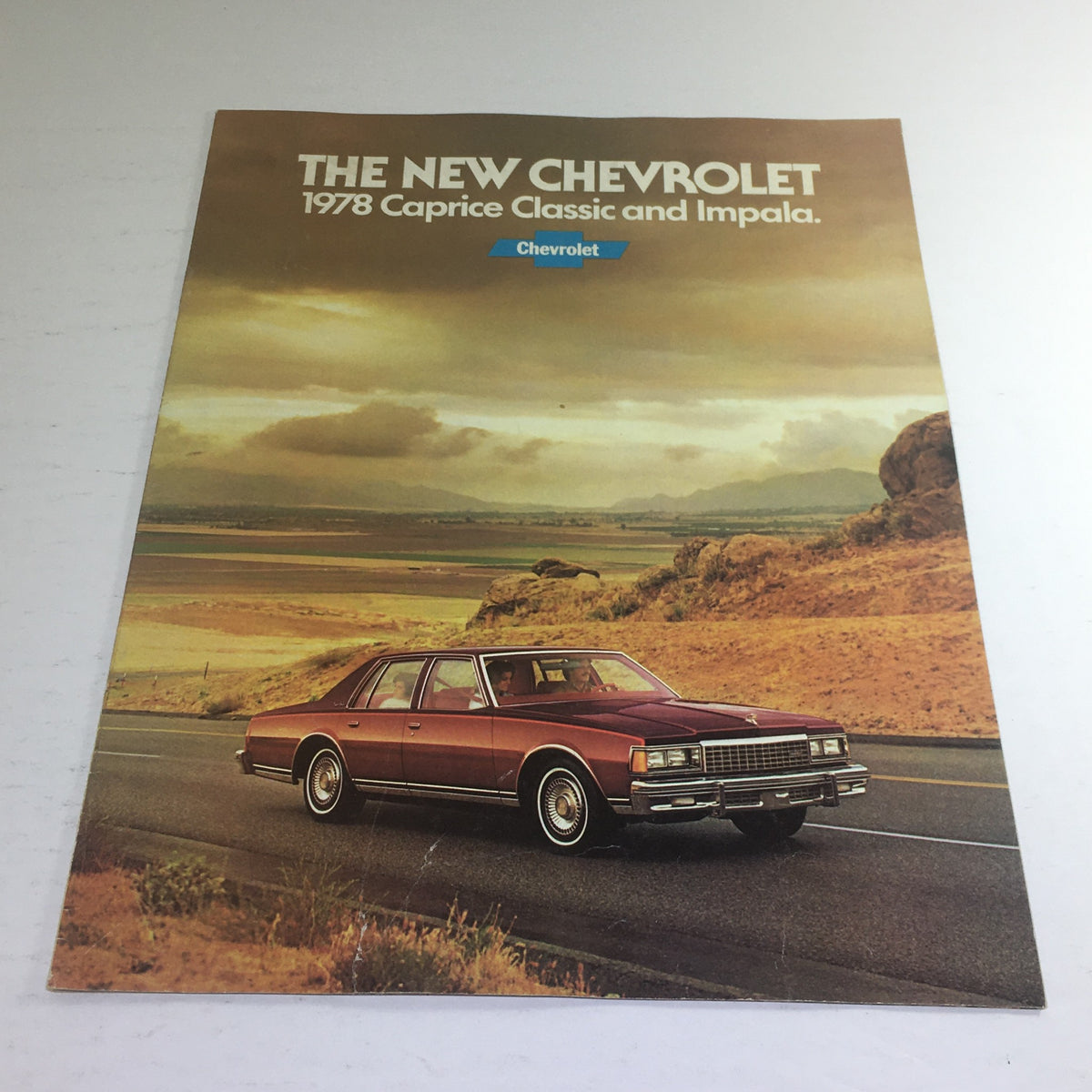 Cover of the 1978 Chevrolet Caprice Classic Impala Dealership Car Auto Brochure Catalog featuring a maroon Caprice Classic parked on a scenic road.