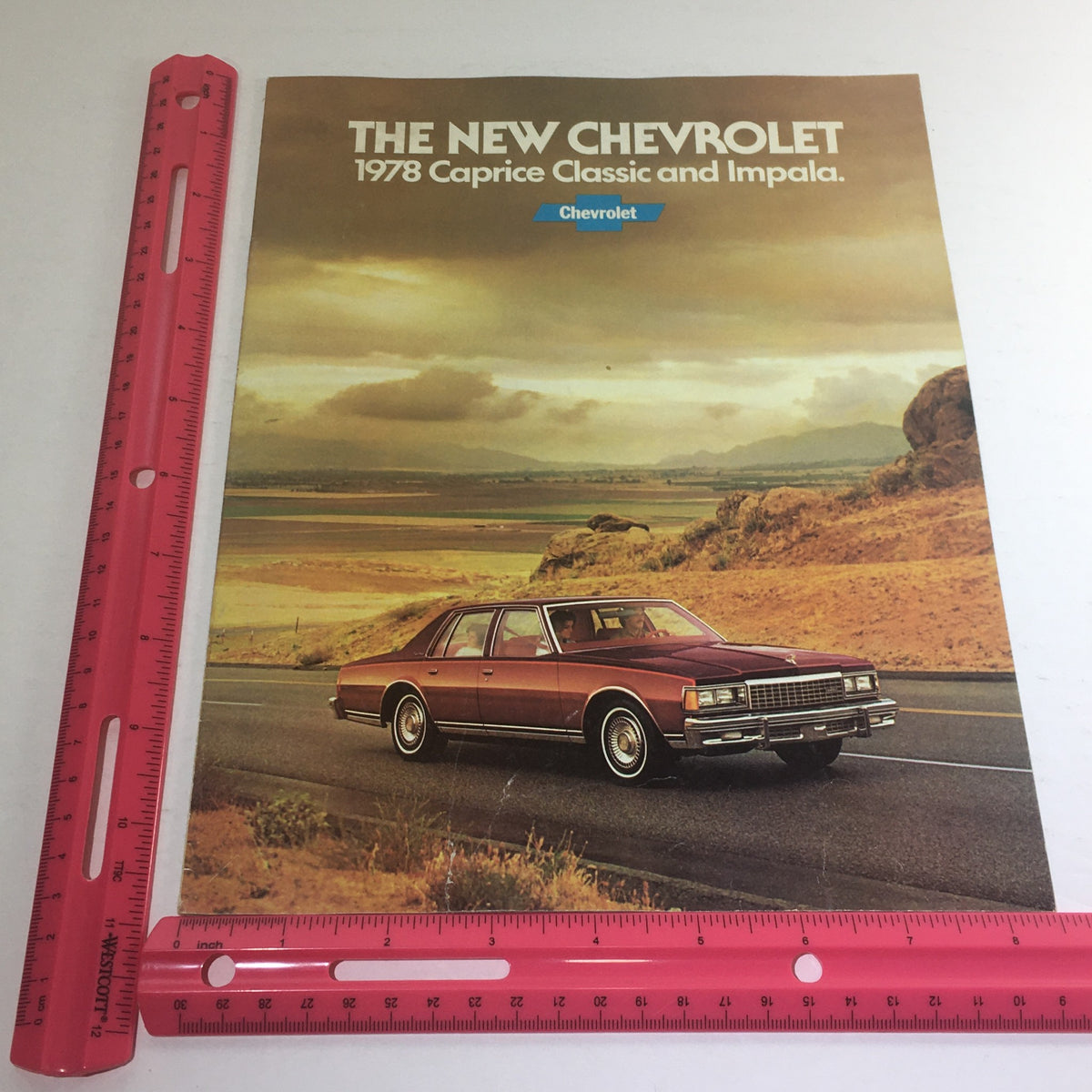 1978 Chevrolet Caprice Classic Impala Dealership Car Auto Brochure Catalog displayed with a ruler for size reference, showcasing the stylish design and picturesque background.