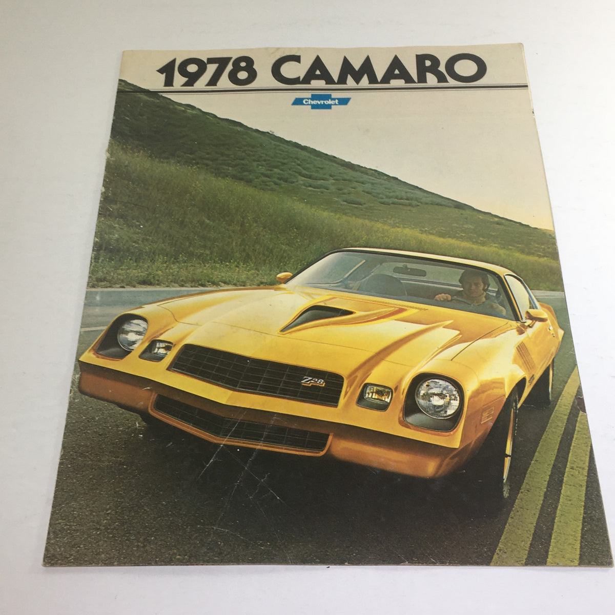 1978 Chevrolet Camaro Rally Sport Dealership Car Auto Brochure Cover featuring a vibrant yellow Camaro on a scenic road.