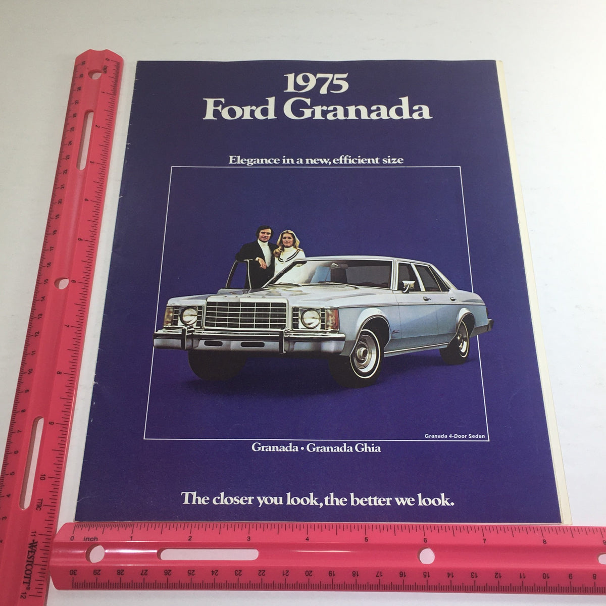 Another view of the 1975 Ford Granada Ghia Sedan brochure cover marked with a ruler for size reference, showcasing the stylish design and promotional text.