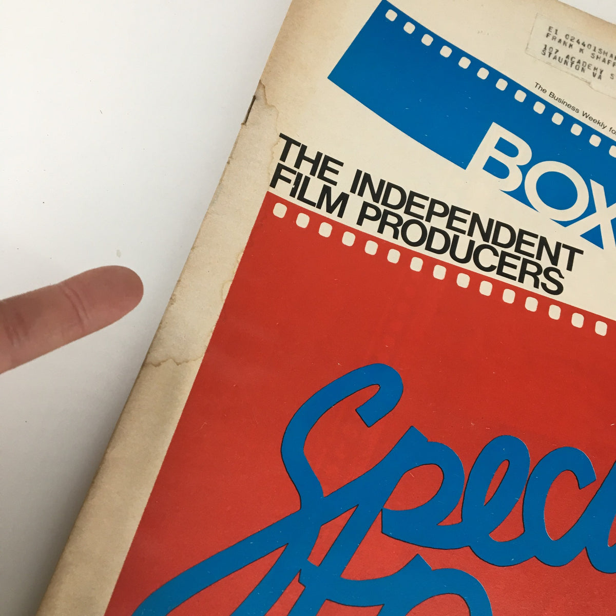 Close-up of the Box Office Magazine October 31 1979 The Independent Film Producers cover, highlighting the title 'Special Report' with a finger pointing towards the edge, revealing its vintage paper quality and wear.