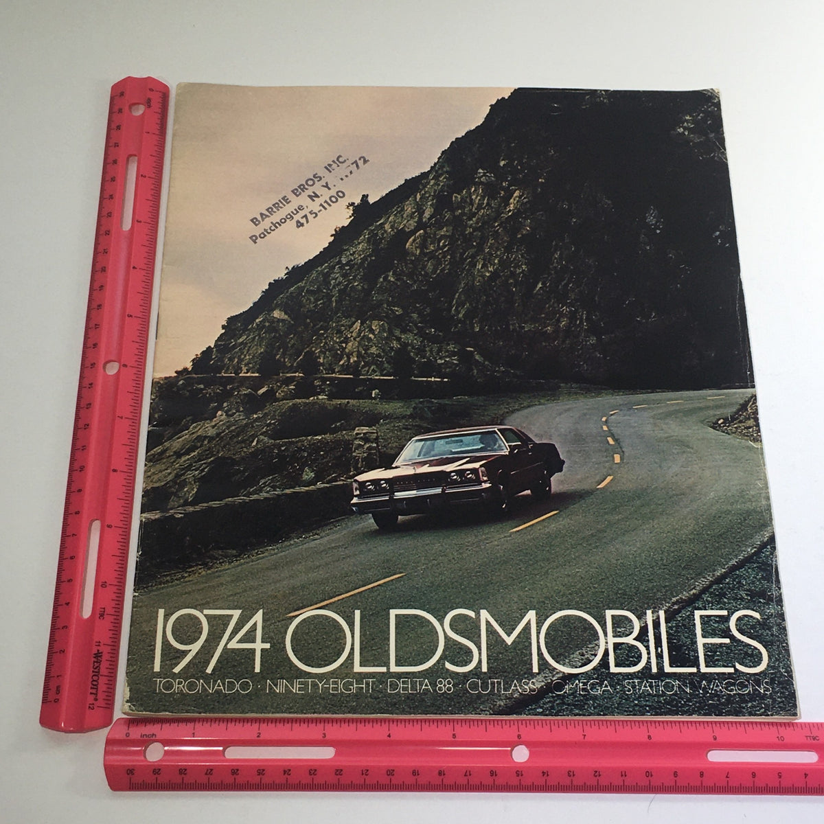 1974 Oldsmobile Toronado-Ninety-Eight Dealership Car Auto Brochure Catalog cover shown next to a ruler for size reference.