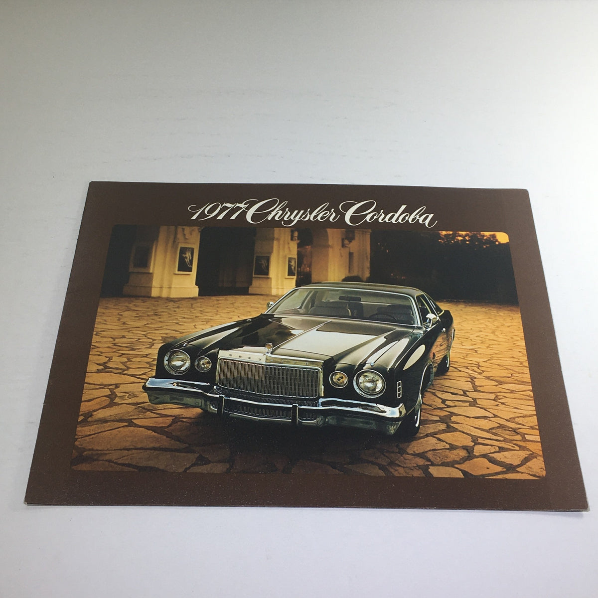 Front view of a 1977 Chrysler Cordoba showcasing its design, featuring a sleek black exterior, as part of the 1977 Chrysler Cordoba Halo Roof Dealership Car Auto Brochure Catalog.
