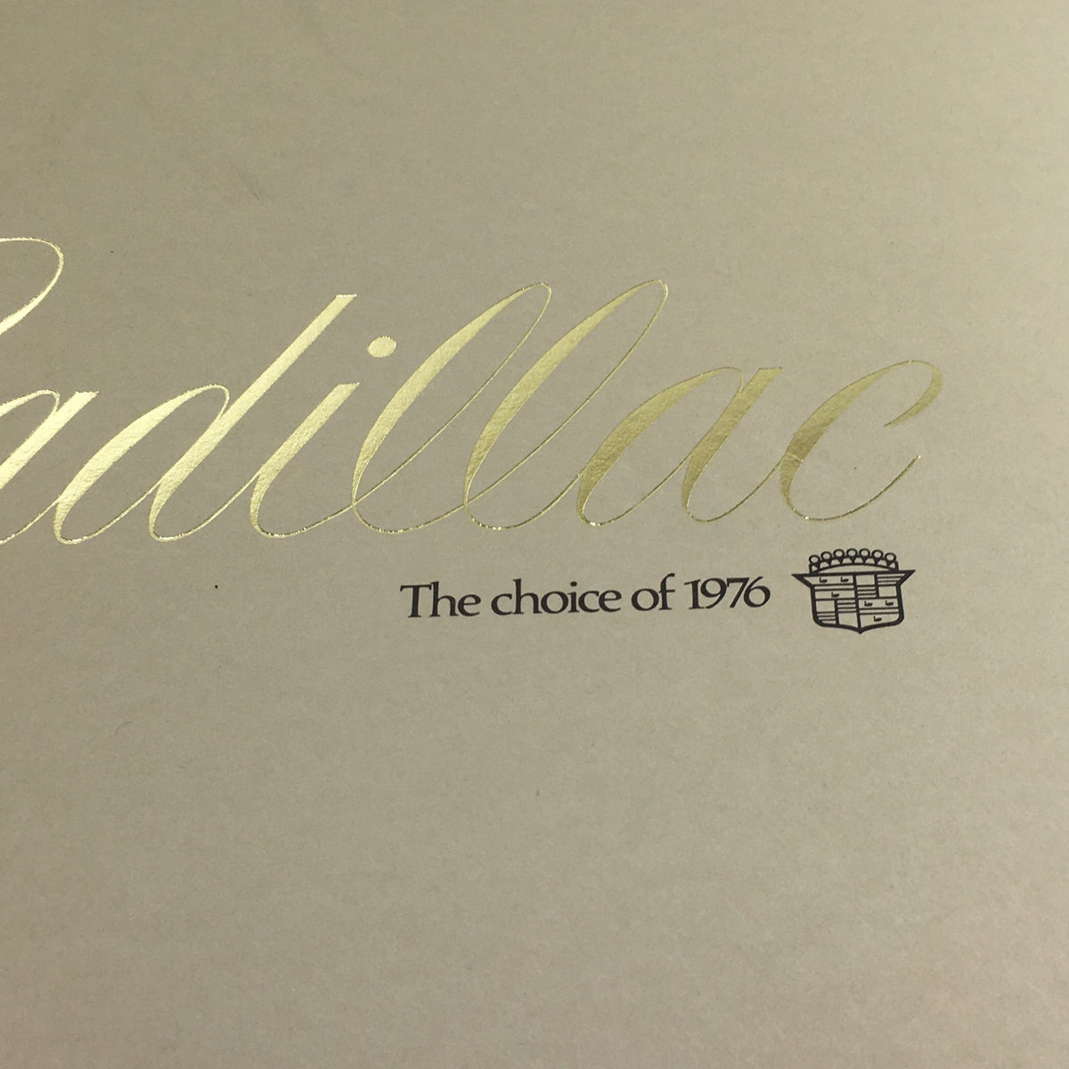 1976 Cadillac Seville and El Dorado Dealership Car Auto Brochure Cover with gold lettering highlighting 'Cadillac' and 'The choice of 1976'.