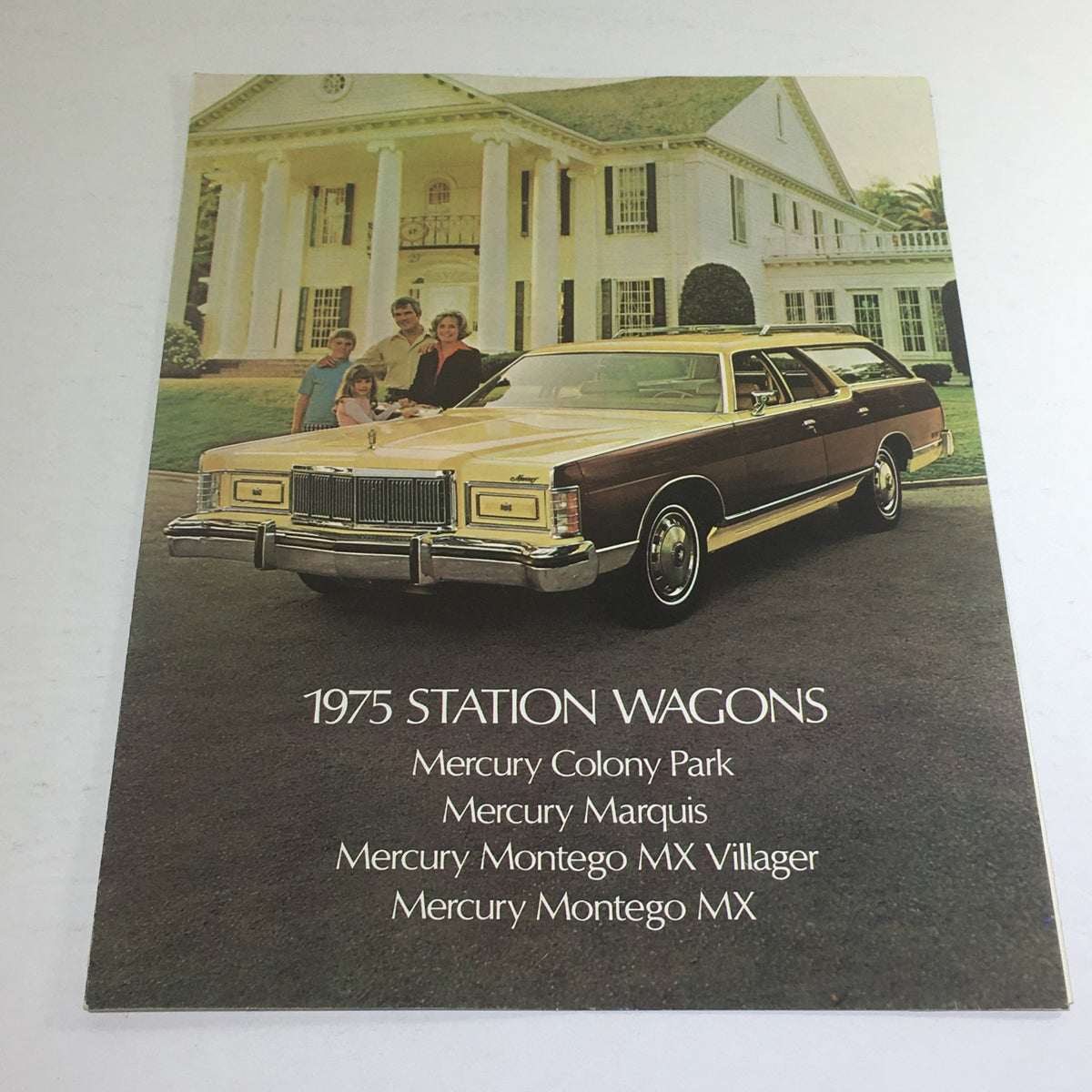 1975 Mercury Station Wagons Colony Park MX Villager Dealership Car Auto Brochure featuring a family standing next to a yellow Mercury station wagon in front of a grand home.