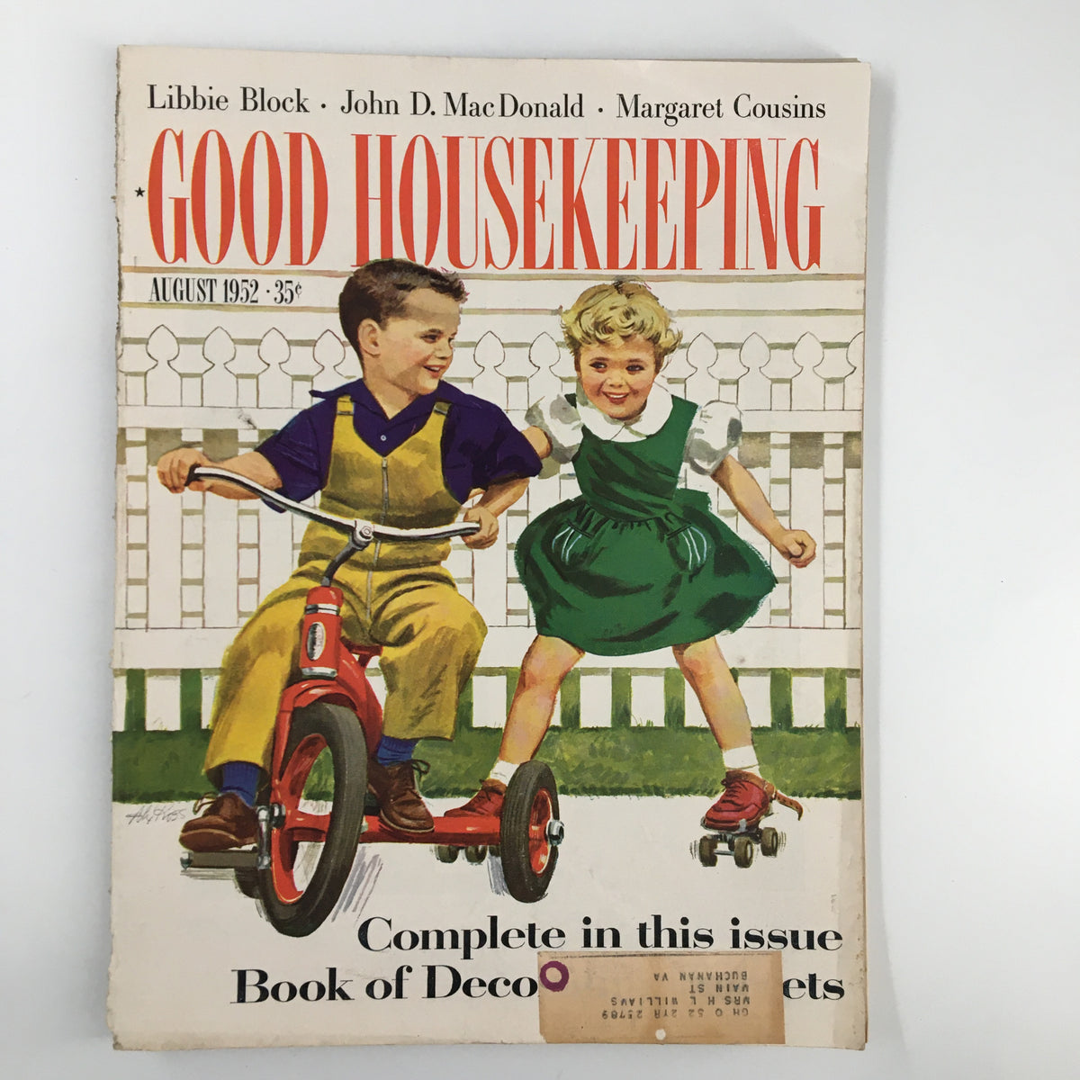 Cover of Good Housekeeping Magazine from August 1952 featuring children playing outside, including a boy on a tricycle and a girl on roller skates.
