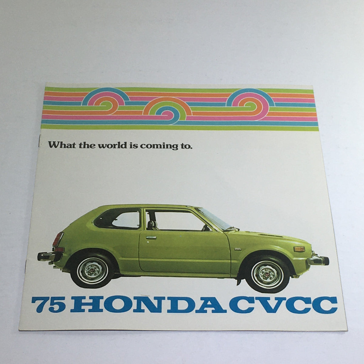 1975 Honda CVCC Specifications Dealership Car Auto Brochure featuring a side view of a green Honda CVCC with stylish retro design and colorful header.