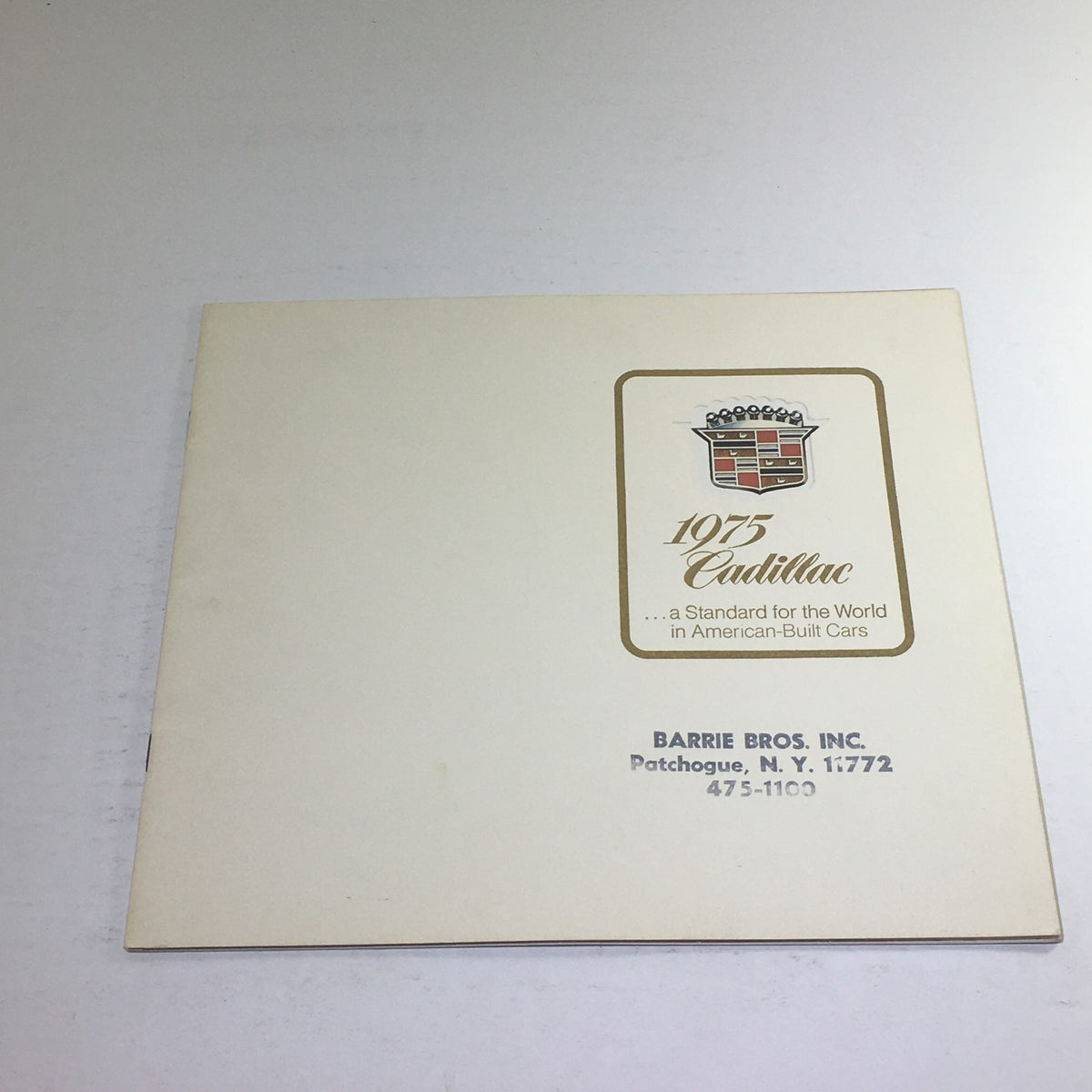 Cover of the 1975 Cadillac American-Built Showroom Dealership Car Auto Brochure Catalog, featuring the Cadillac logo and dealership information.