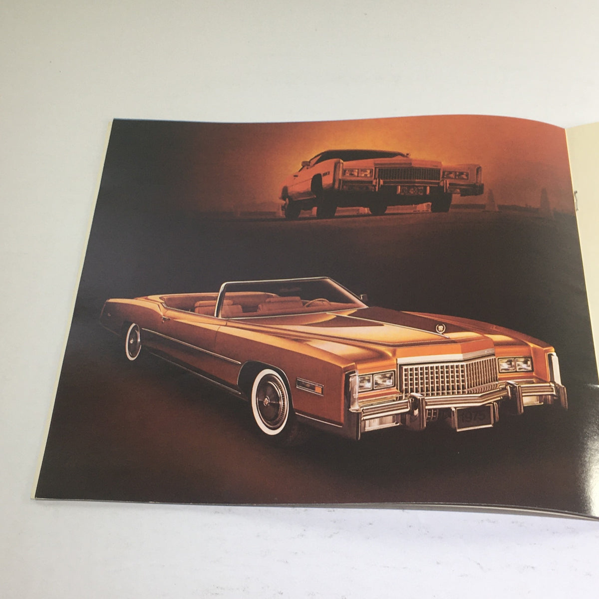 Illustration from the 1975 Cadillac American-Built Showroom Dealership Car Auto Brochure Catalog showcasing a classic Cadillac convertible car.
