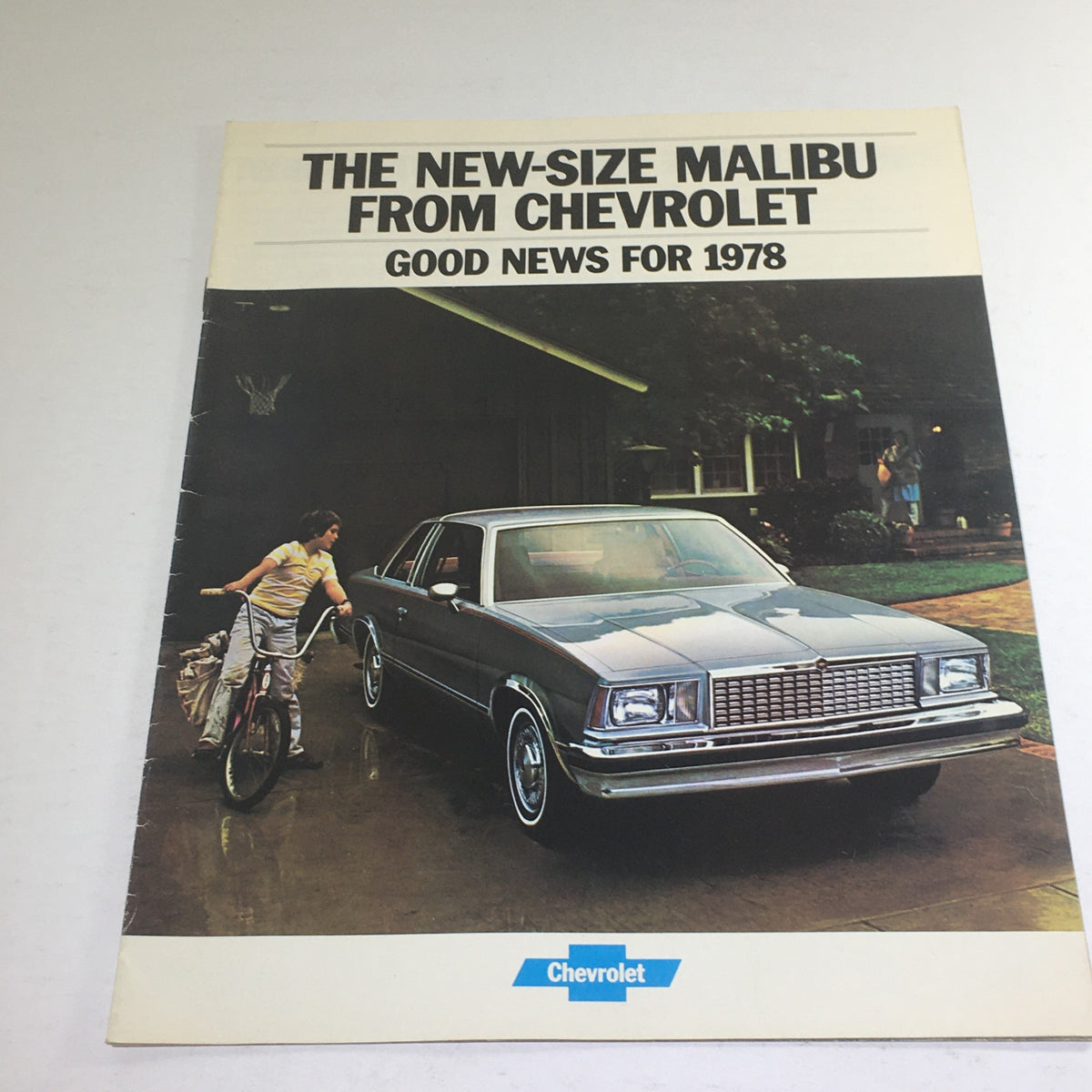 1978 Chevrolet New-Size Malibu Squire Dealership Car Auto Brochure Catalog cover featuring a sleek car parked in front of a house with a person riding a bicycle.