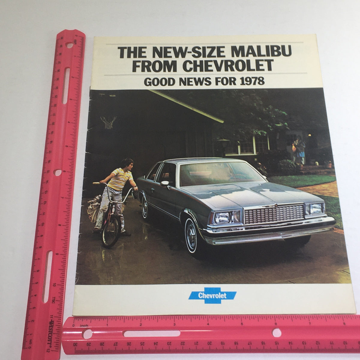 1978 Chevrolet New-Size Malibu Squire Dealership Car Auto Brochure Catalog displaying the Malibu model with a focus on its design and features, including a scene of a cyclist and the vehicle.