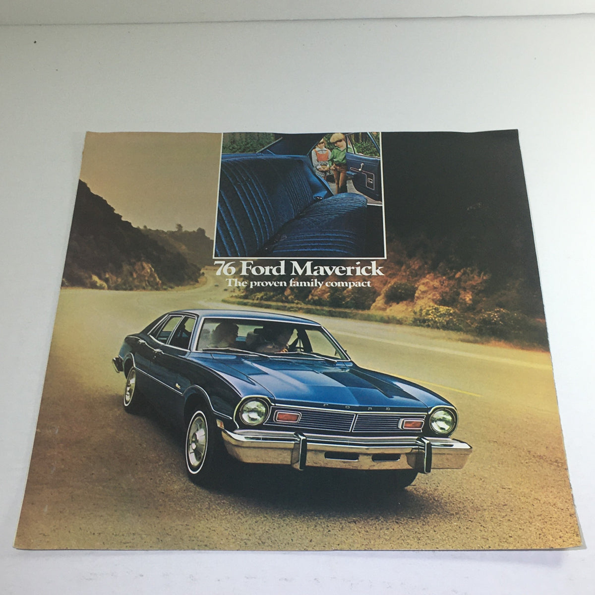 1976 Ford Maverick Sedan Dealership Car Auto Brochure Catalog, featuring a blue Ford Maverick on a scenic road, showcasing its design and capabilities.
