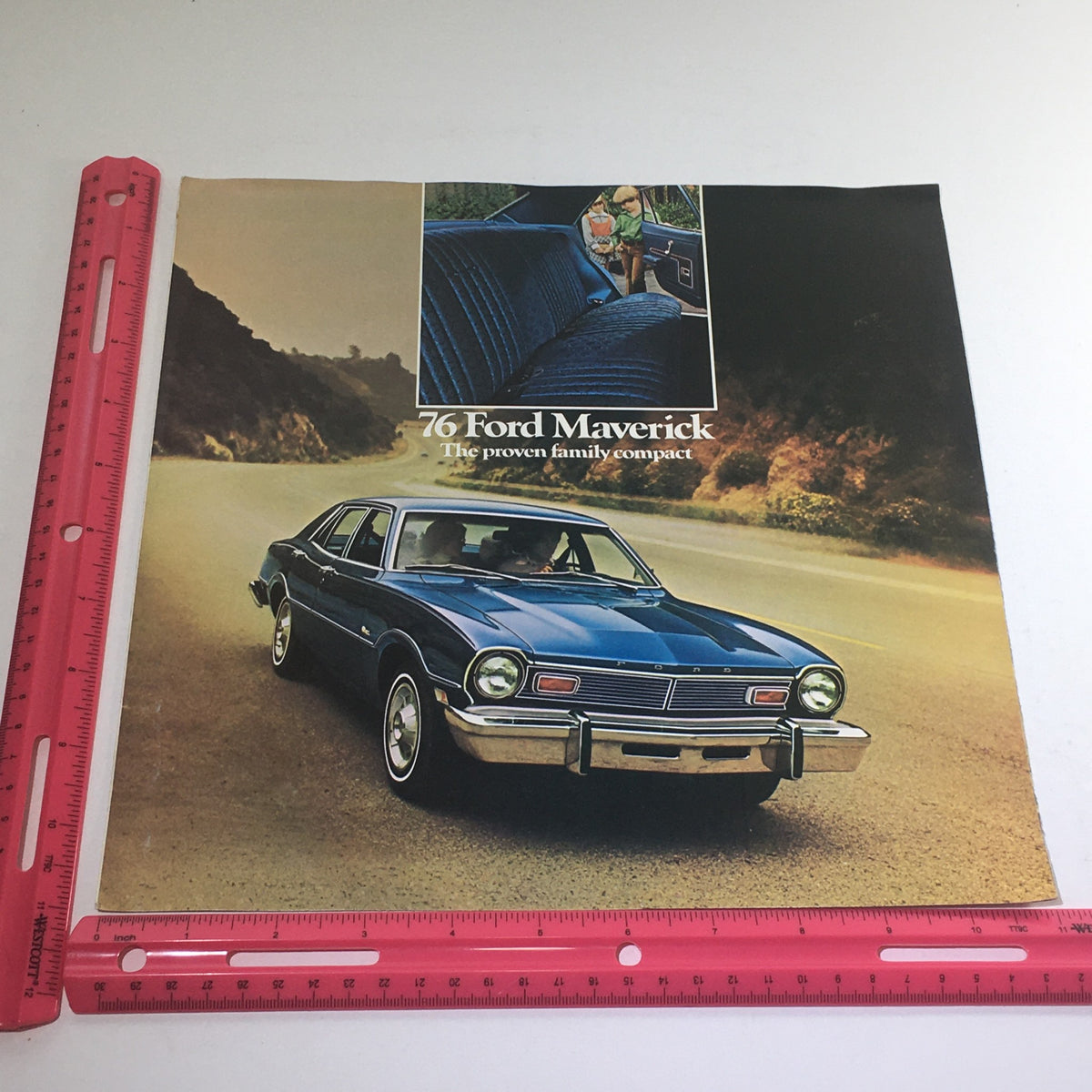 1976 Ford Maverick Sedan Dealership Car Auto Brochure Catalog with an eye-catching image of the blue Ford Maverick on the road highlighting its design and family-friendly features.