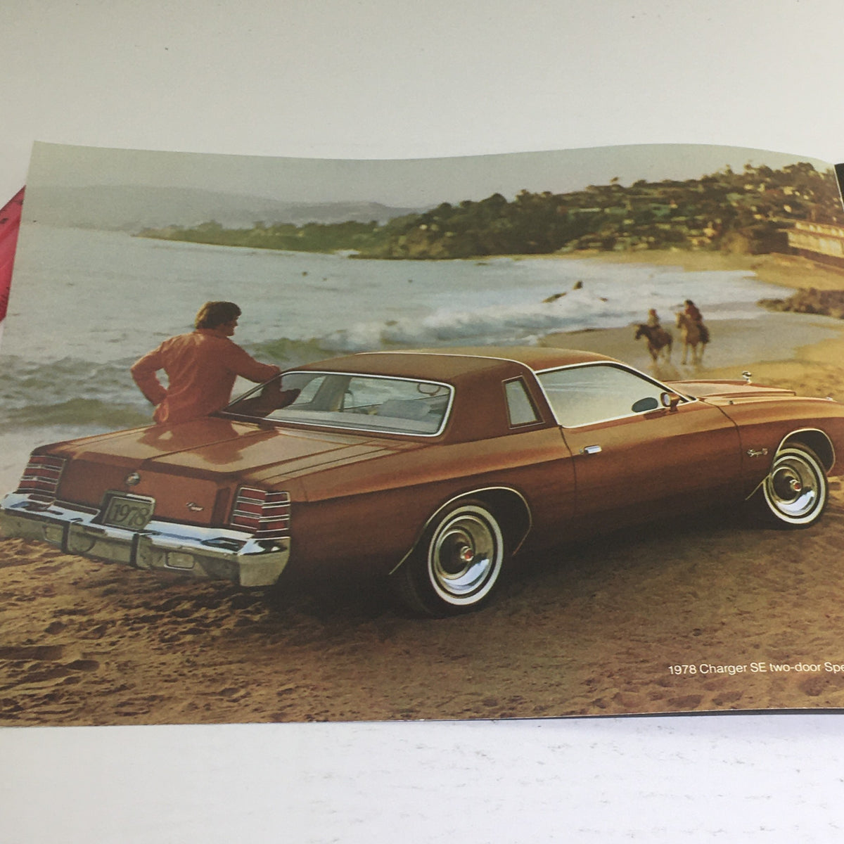 1978 Dodge Charger SE two-door sport coupe displayed along a beach, highlighting its retro appeal and remarkable craftsmanship.