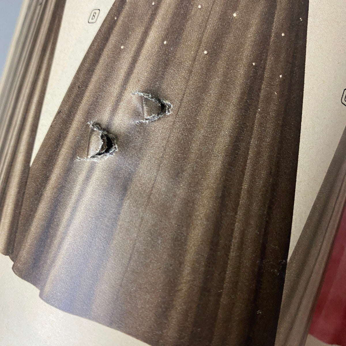 Close-up detail of the interior of the 1952 Montgomery Ward Albany Spring and Summer Catalog, displaying wear on a page featuring a unique dress design.