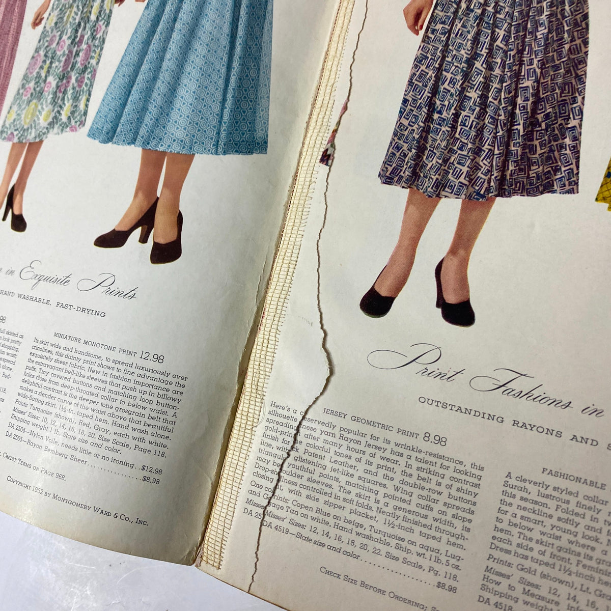 Detail from the 1952 Montgomery Ward Albany Spring and Summer Catalog showcasing exquisite print dresses, highlighting visible wear on the page.