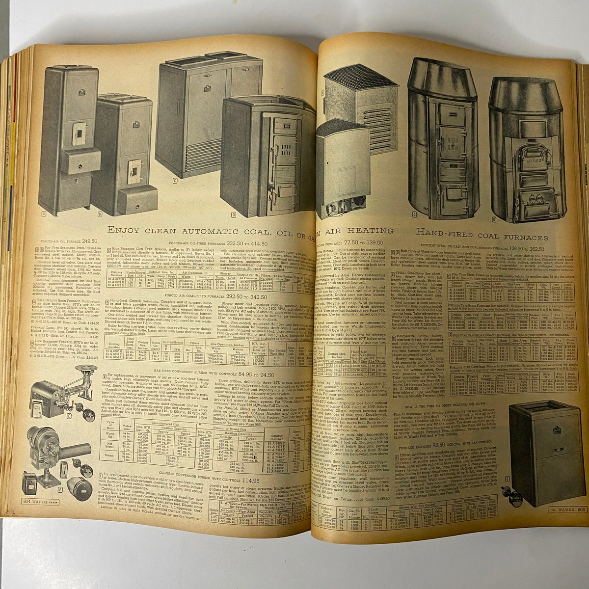 Heating solutions page from the 1952 Montgomery Ward Albany Spring and Summer Catalog, featuring coal and oil heating systems along with pricing, representing home heating technology of the era.