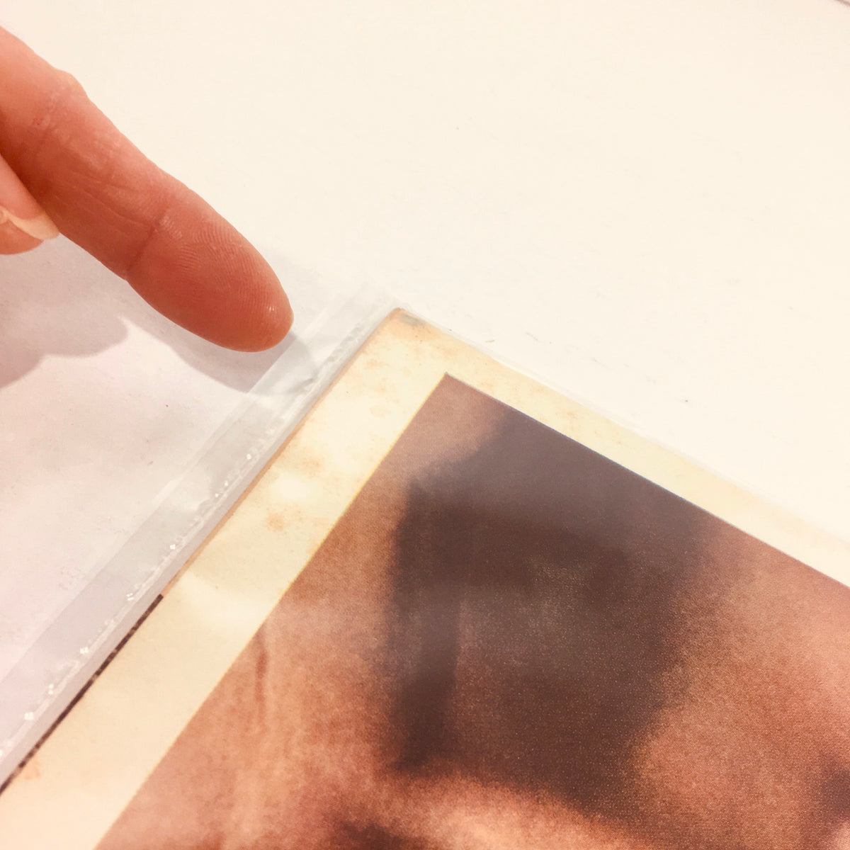 Close-up view of the edge of a vintage Life Magazine from March 31, 1972, showing protective plastic covering and details of wear.